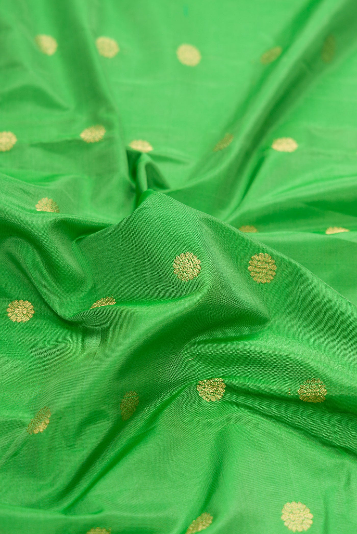 Close up of Parrot Green Dual Tone Blended Paithani Silk Saree with Zari Butta on the body and Paithani Border.  displaying folds