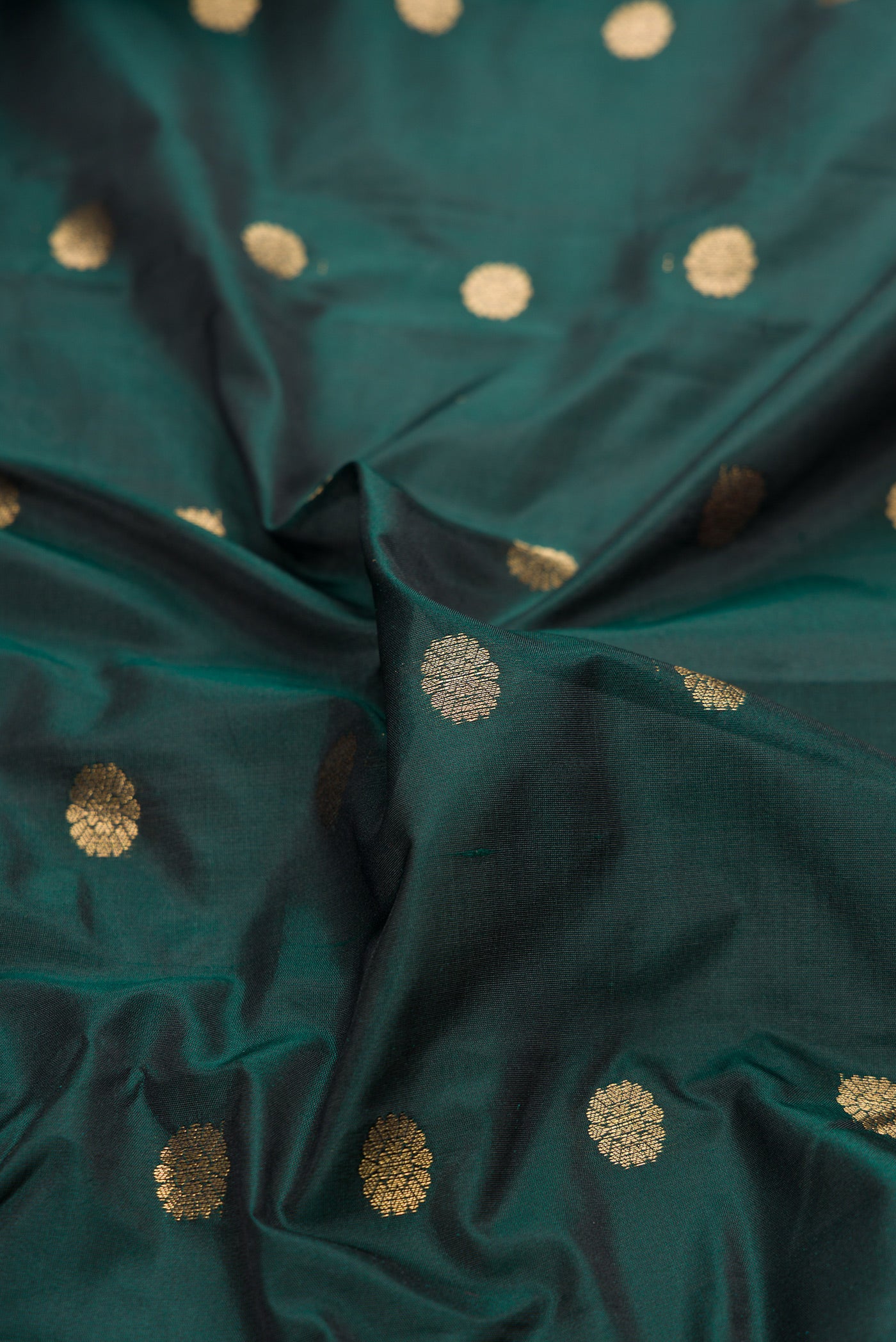 Close up of Bottle Green Dual Tone Blended Paithani Silk Saree with Zari Butta on the body and Zari Border.  displaying folds
