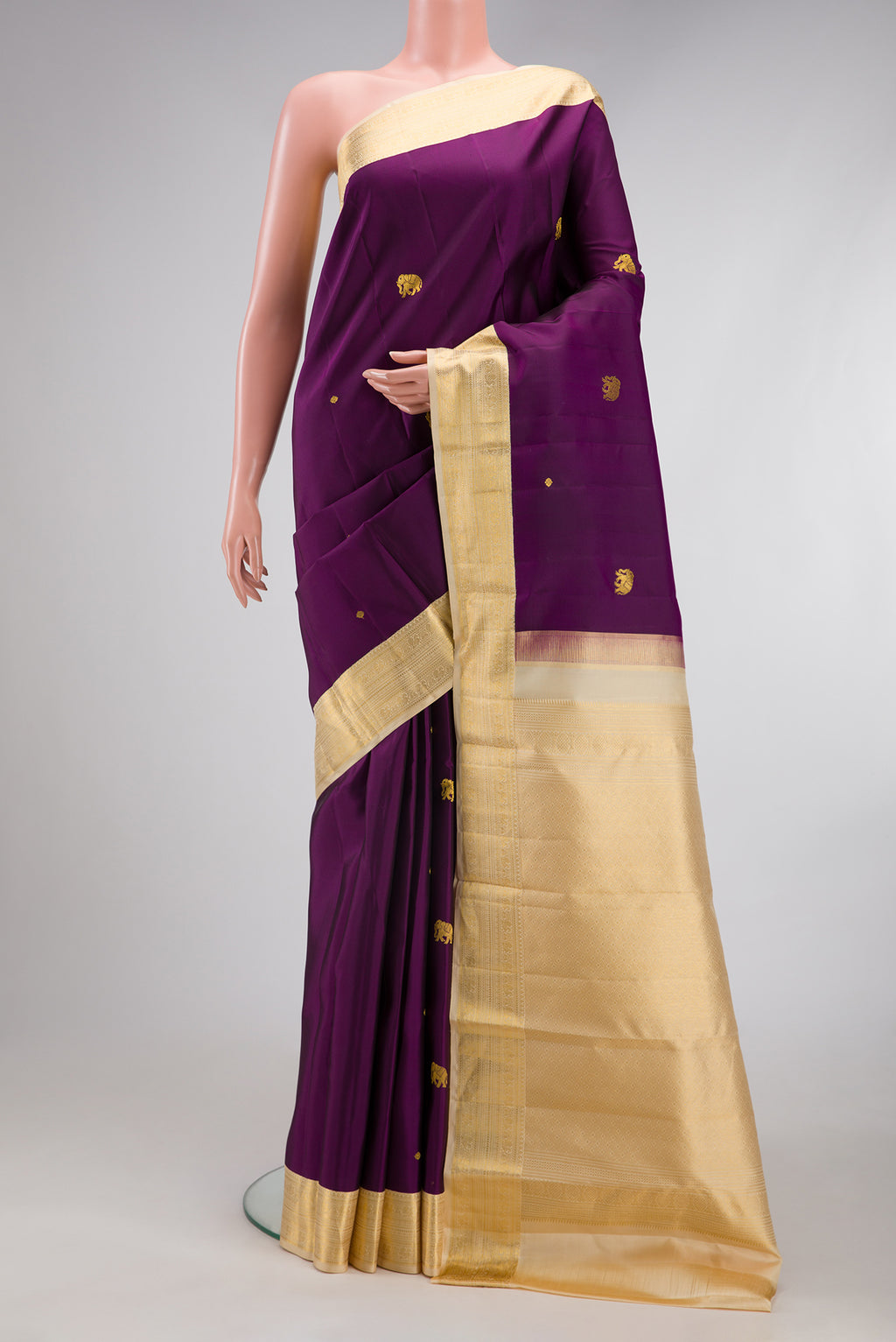 Purple Kanchipuram Silk Saree with Zari Butta on the body and Zari Border.  displayed on a mannequin