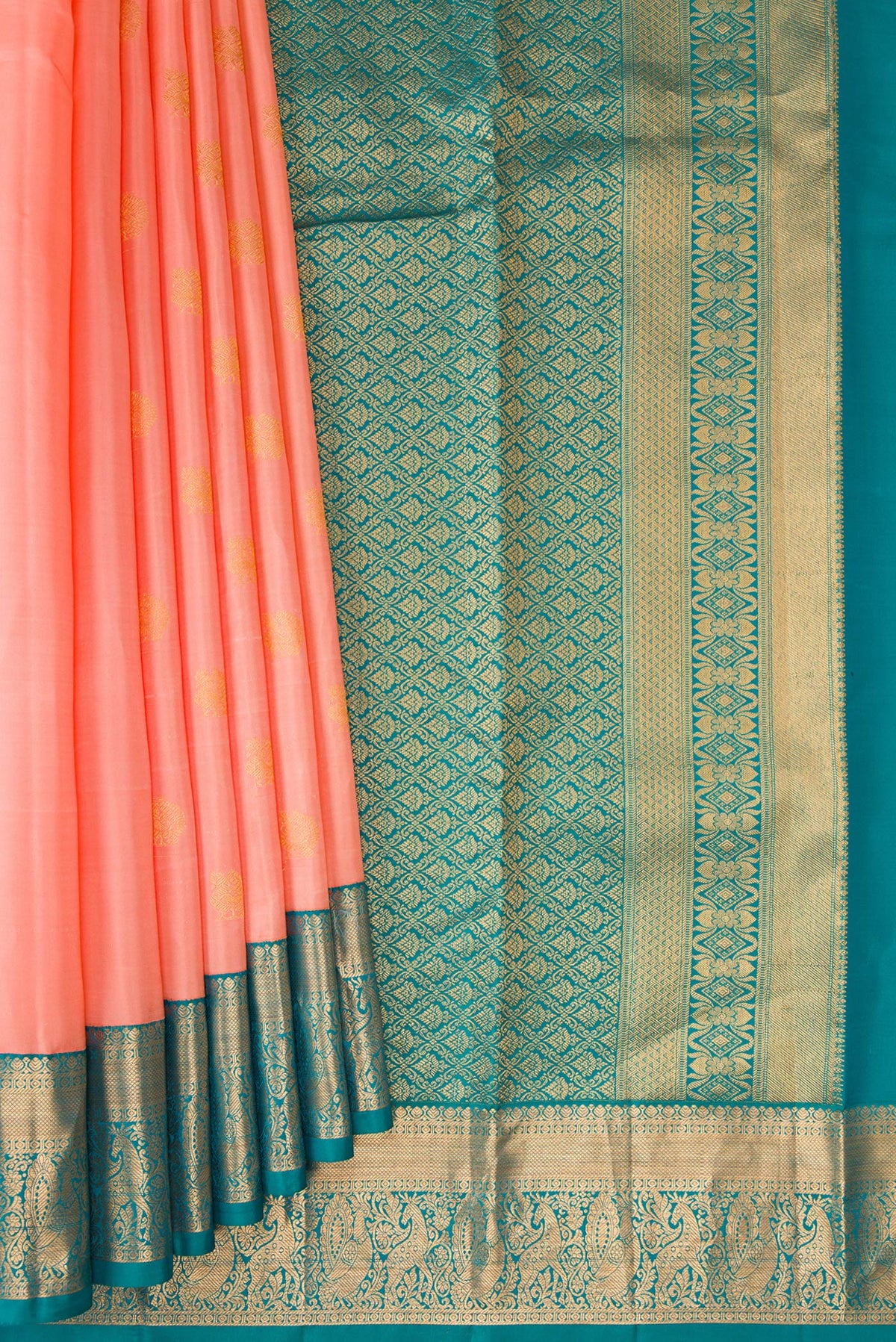 Pleats and pallu of Peach Kanchipuram Silk Saree with Zari Butta on the body and Zari Border. 