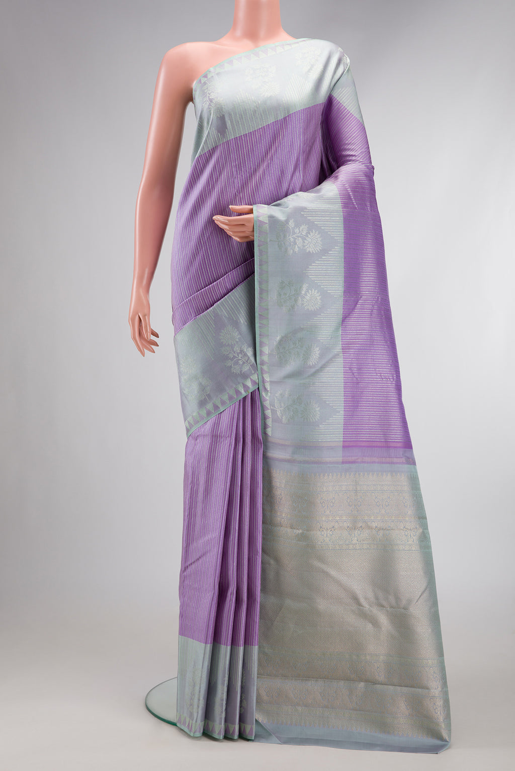 Lavender Dual Tone Kanjivaram Silk Saree with Stripes on the body and Zari Border.  displayed on a mannequin