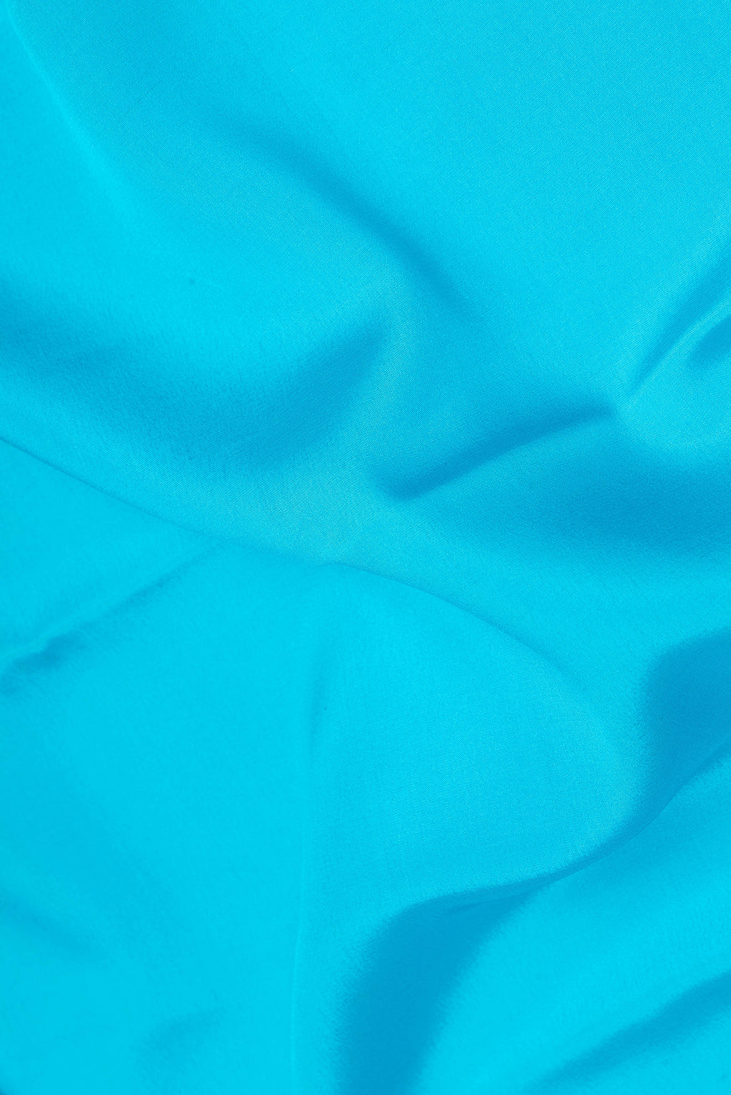 Close up of Sky Blue Mysore Silk Saree with Plain Body and Fancy Border.  displaying folds