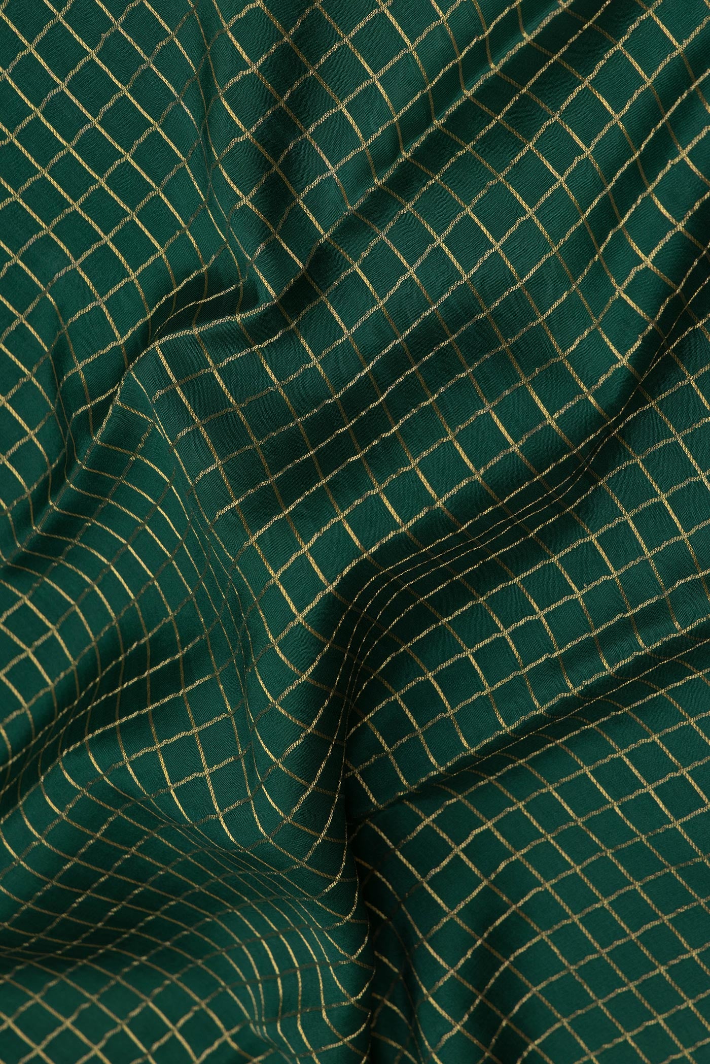 Close up of Bottle Green Mysore Silk Saree with Checked design on the body and Zari Border.  displaying folds