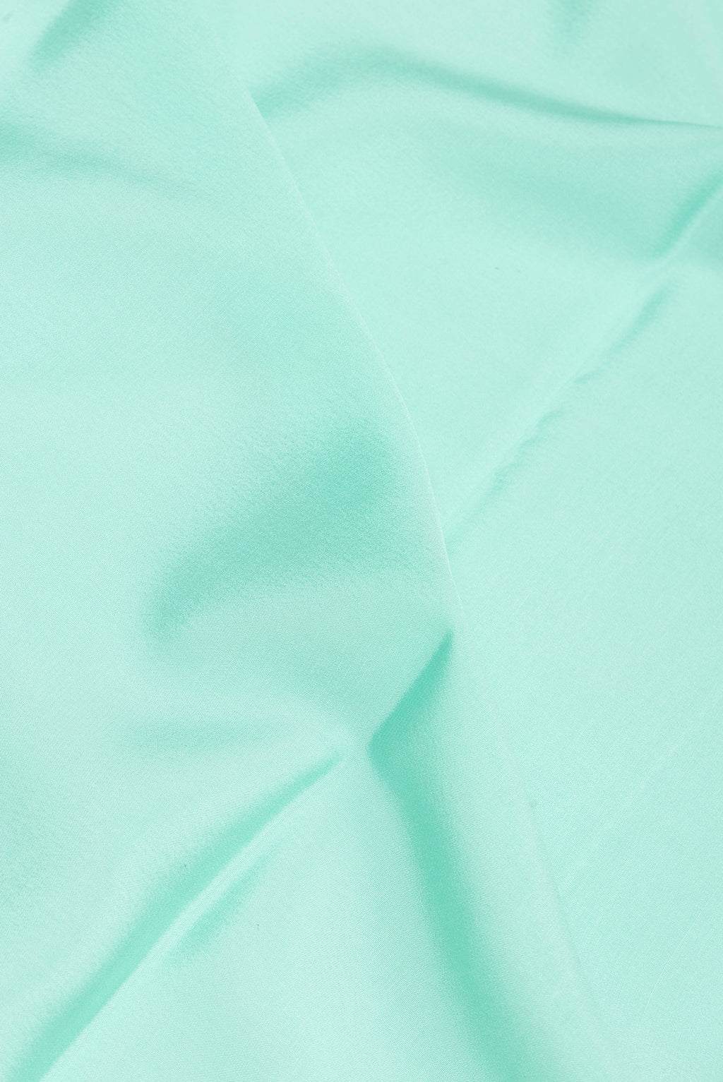 Close up of Pure Silk Sky Blue Mysore Silk Saree with Plain Body and Zari Border.  displaying folds