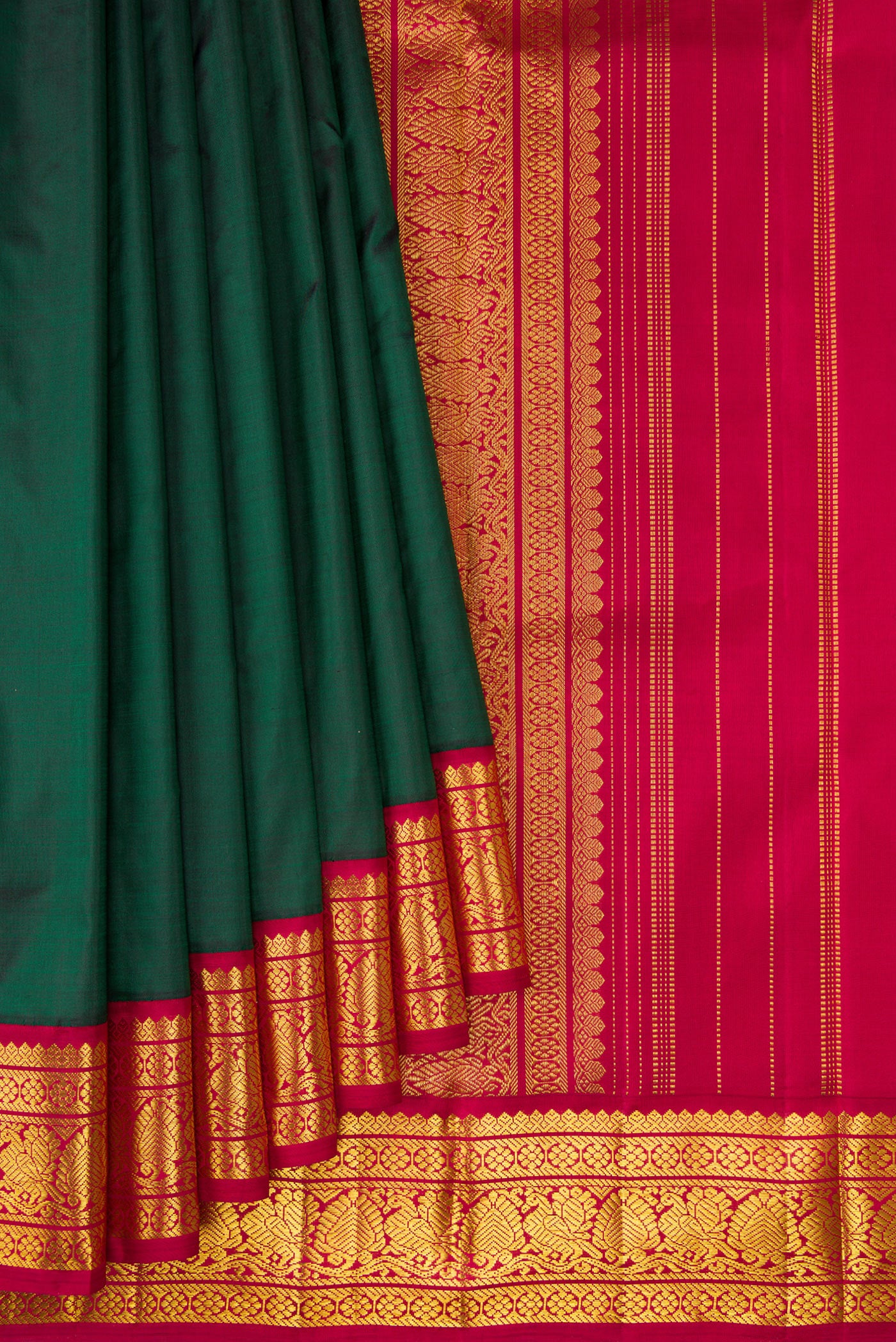 Pleats and pallu of Bottle Green Kanjivaram Silk Saree with Plain Body and Zari Border. 
