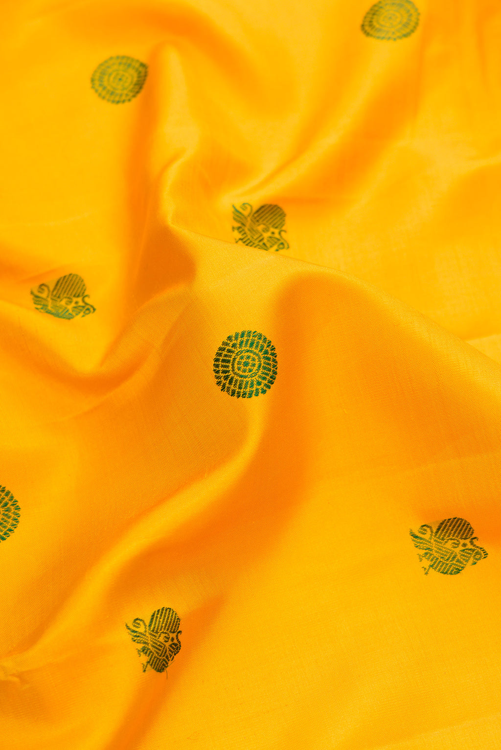 Close up of Yellow Dual Tone Kanjivaram Silk Saree with Thread Butta on the body and Fancy Border.  displaying folds