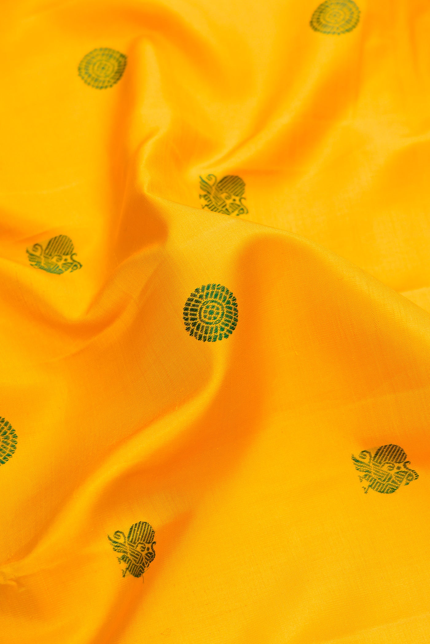 Close up of Yellow Dual Tone Kanjivaram Silk Saree with Thread Butta on the body and Fancy Border.  displaying folds
