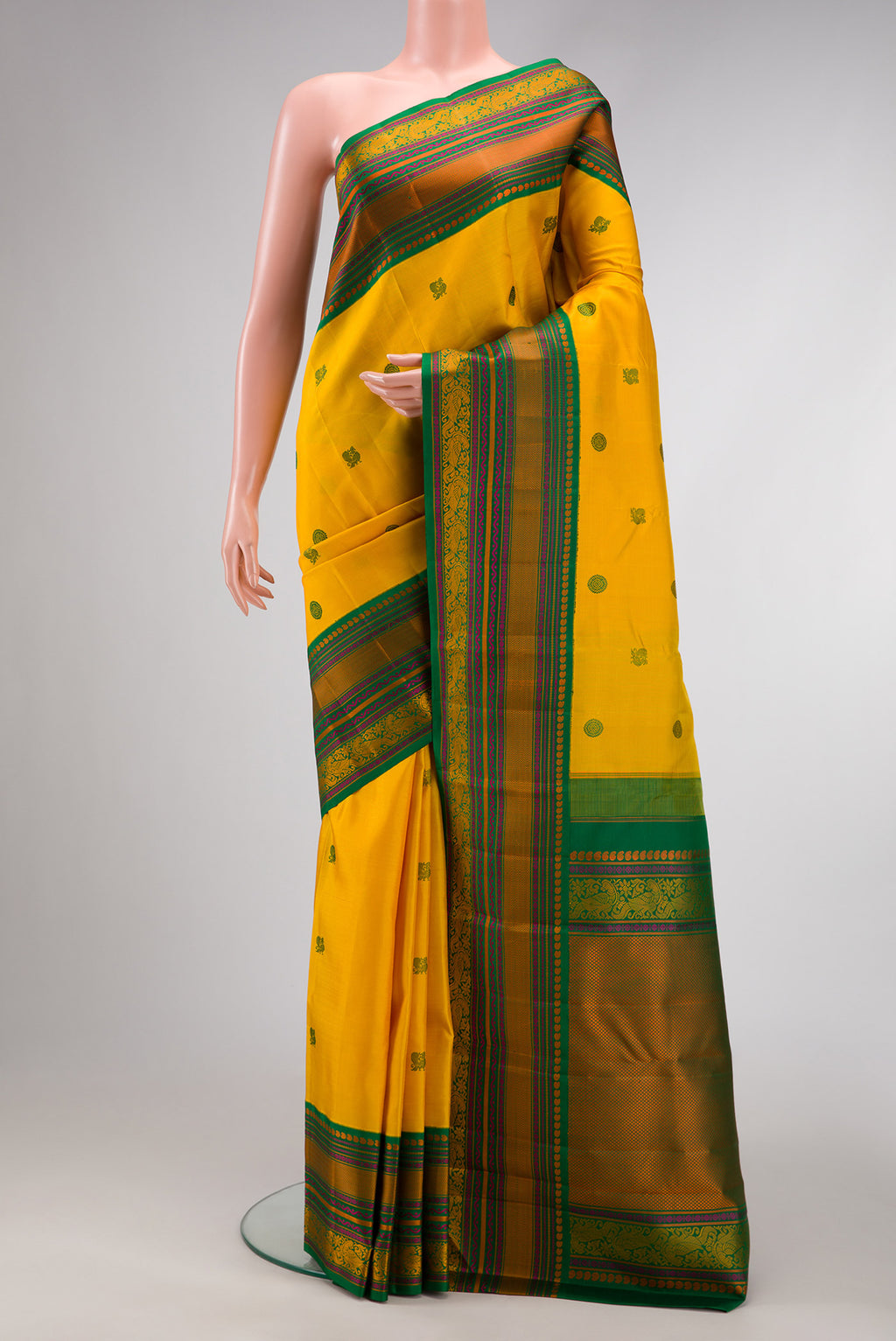 Yellow Dual Tone Kanjivaram Silk Saree with Thread Butta on the body and Fancy Border.  displayed on a mannequin