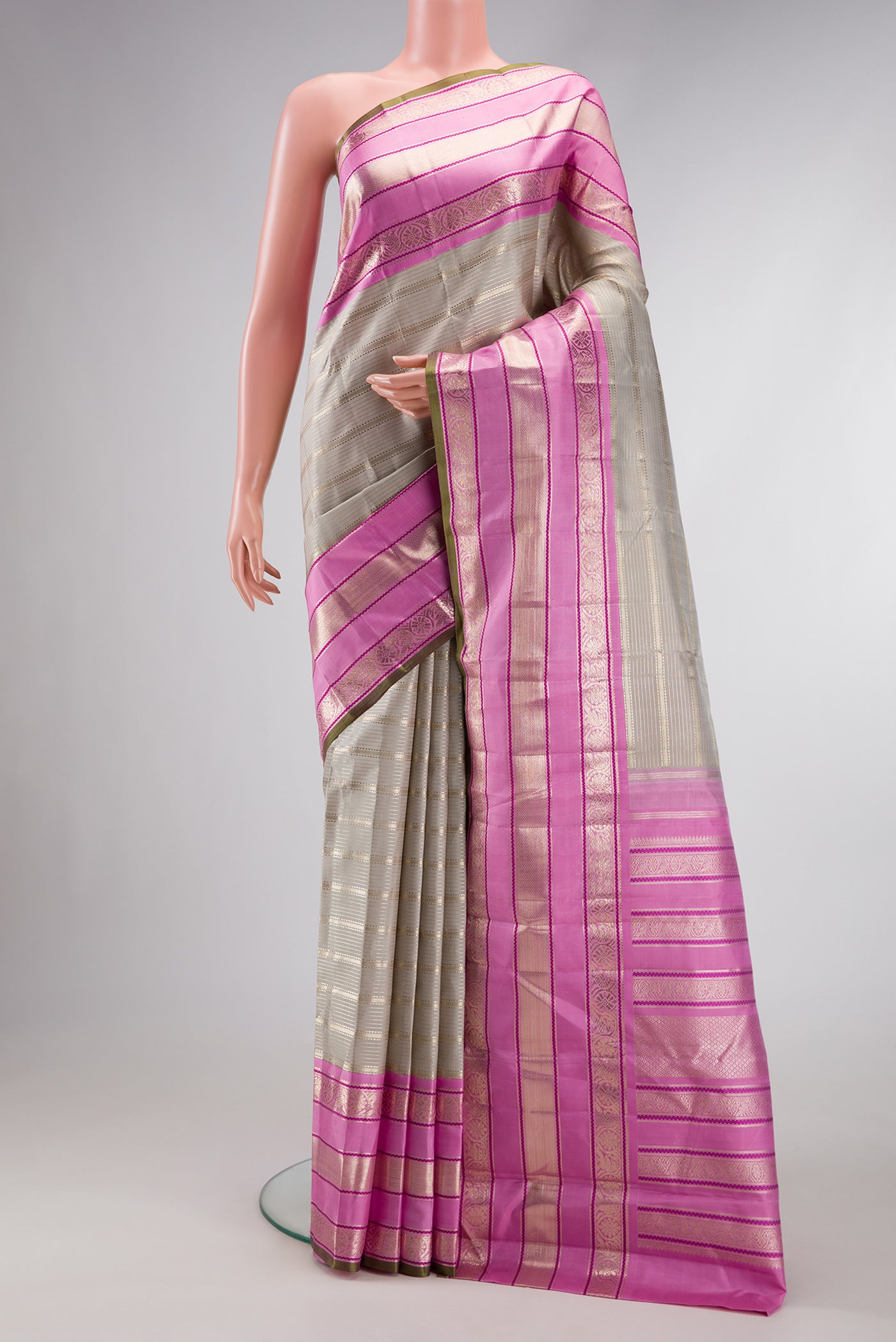 Grey Dual Tone Kanchipuram Silk Saree with Zari Brocade on the body and Zari Border.  displayed on a mannequin