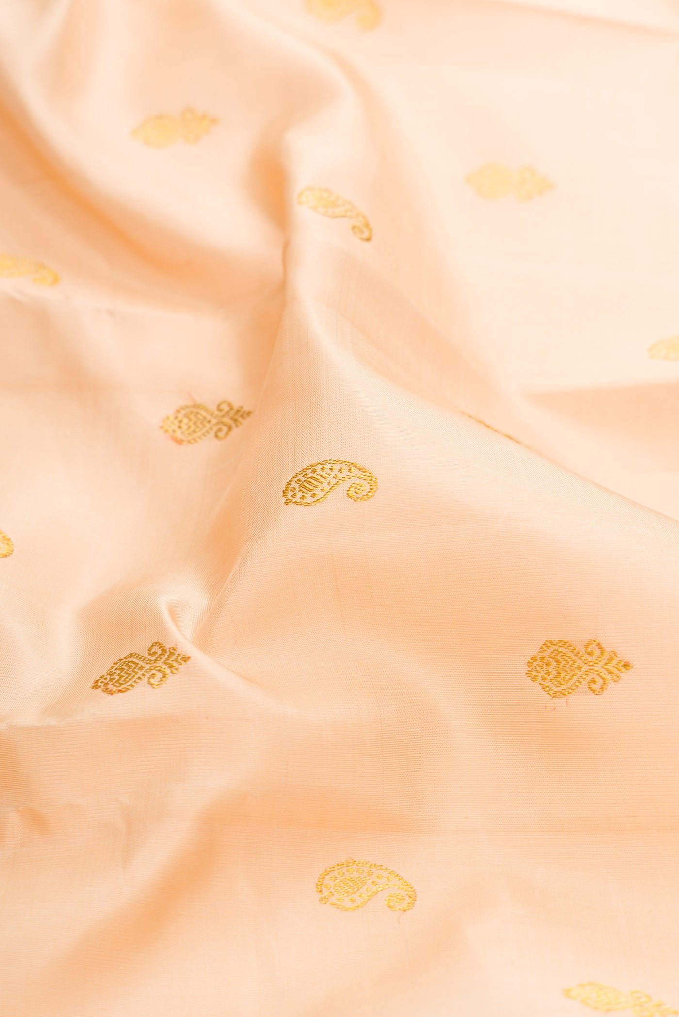 Close up of Sandal Kanjivaram Silk Saree with Zari Butta on the body and Zari Border.  displaying folds