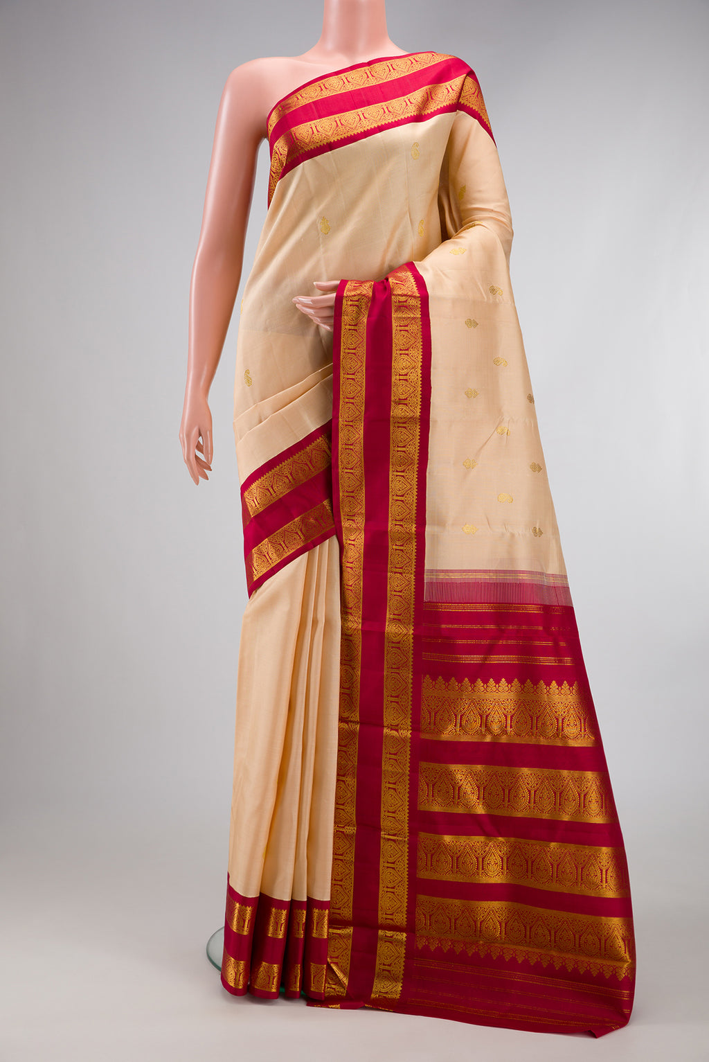 Sandal Kanjivaram Silk Saree with Zari Butta on the body and Zari Border.  displayed on a mannequin