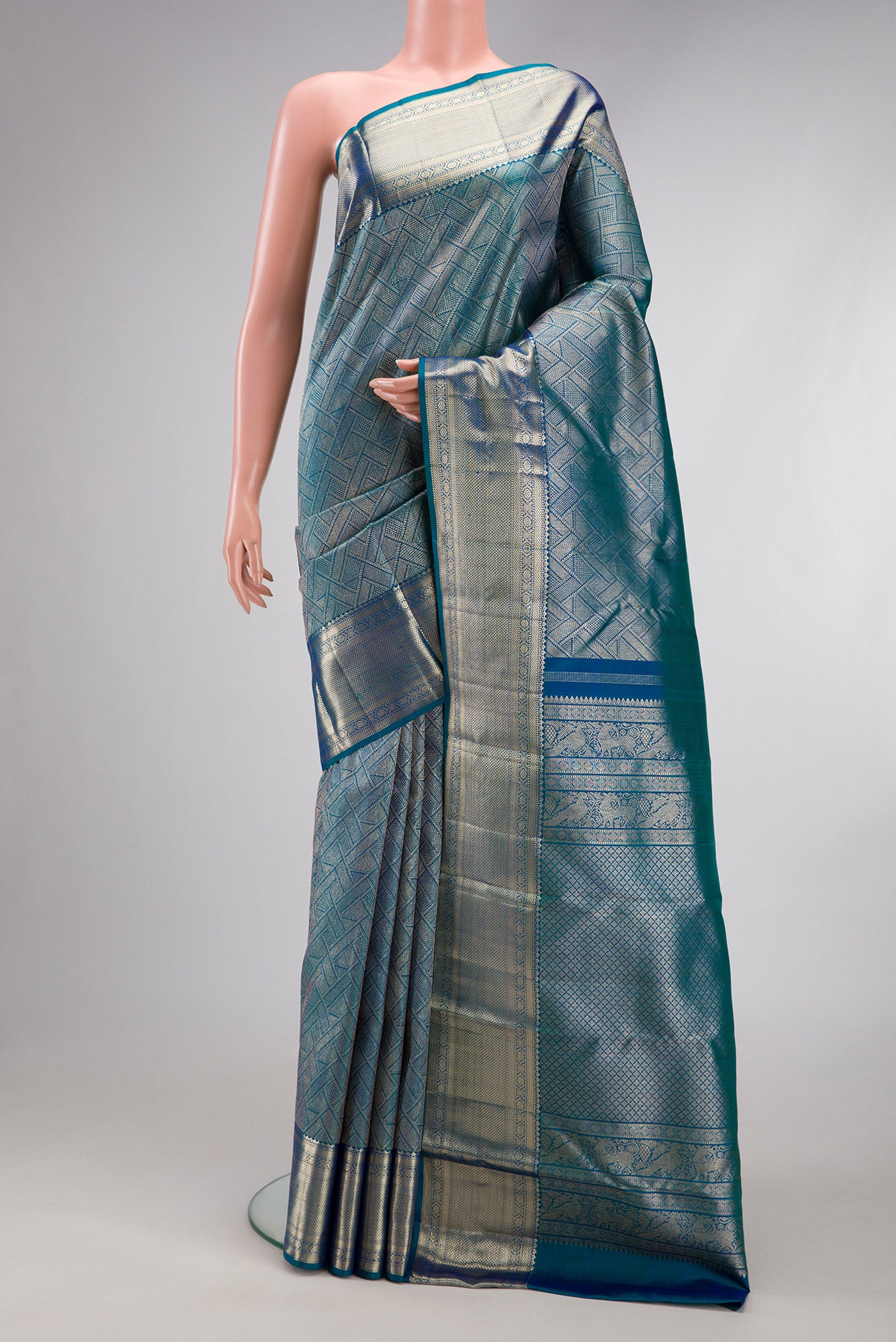Peacock Blue Kanchipuram Silk Saree with Zari Brocade on the body and Fancy Border.  displayed on a mannequin