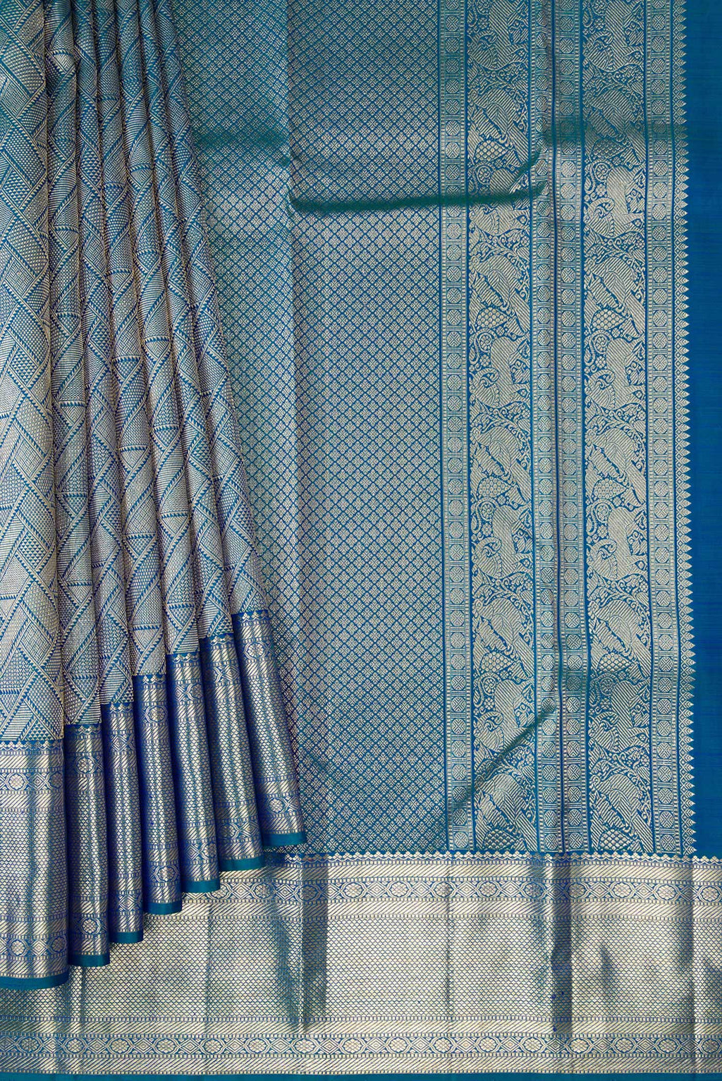 Pleats and pallu of Peacock Blue Kanchipuram Silk Saree with Zari Brocade on the body and Fancy Border. 