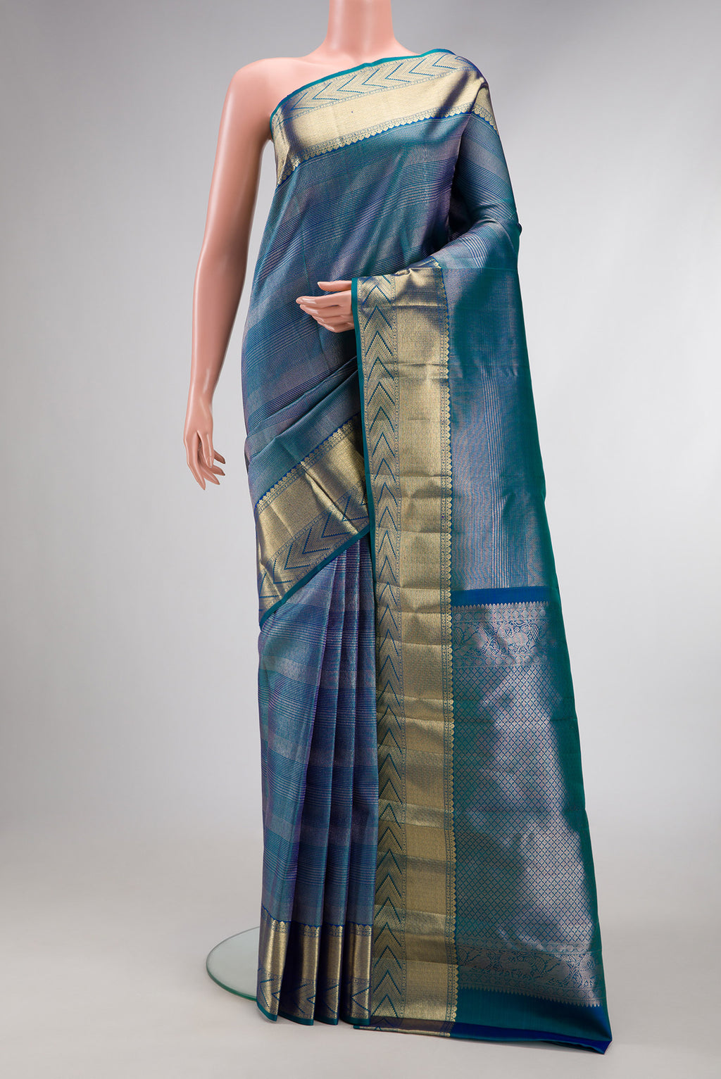 Peacock Blue Dual Tone Kanchipuram Silk Saree with Zari Brocade on the body and Zari Border.  displayed on a mannequin