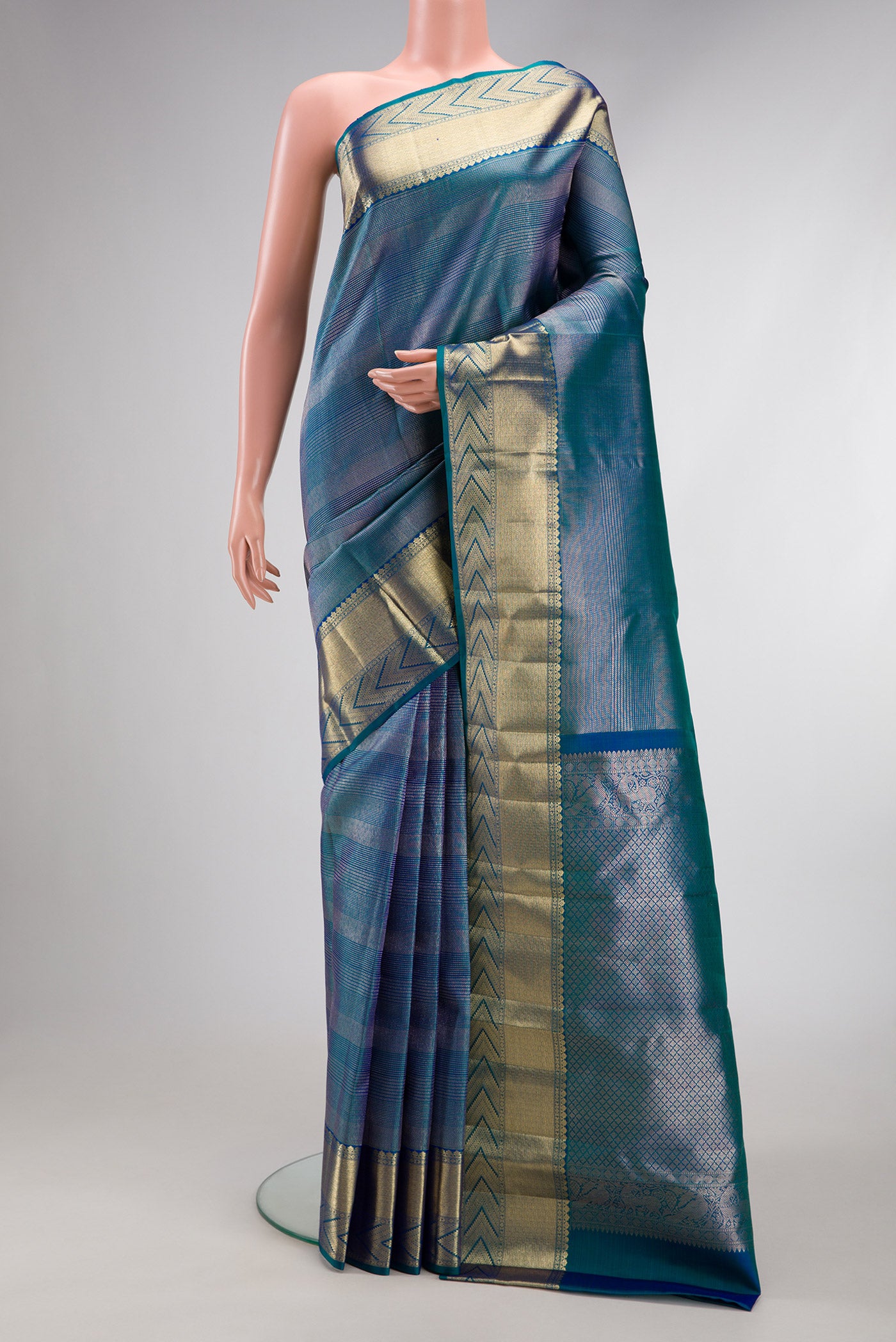 Peacock Blue Dual Tone Kanchipuram Silk Saree with Zari Brocade on the body and Zari Border.  displayed on a mannequin