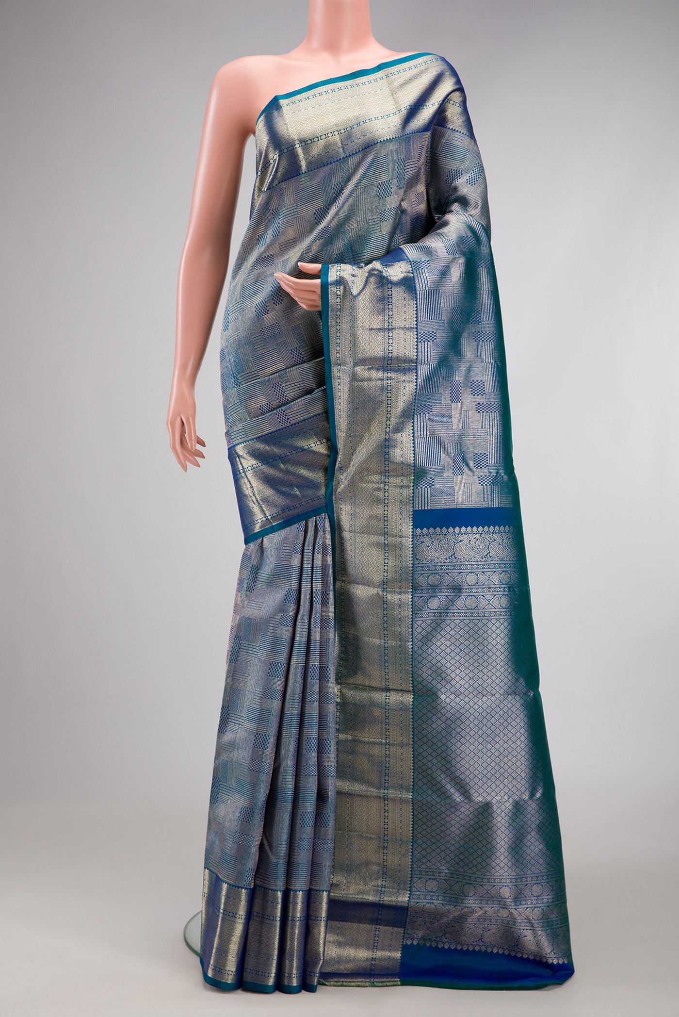 Peacock Blue Kanchipuram Silk Saree with Zari Brocade on the body and Zari Border.  displayed on a mannequin