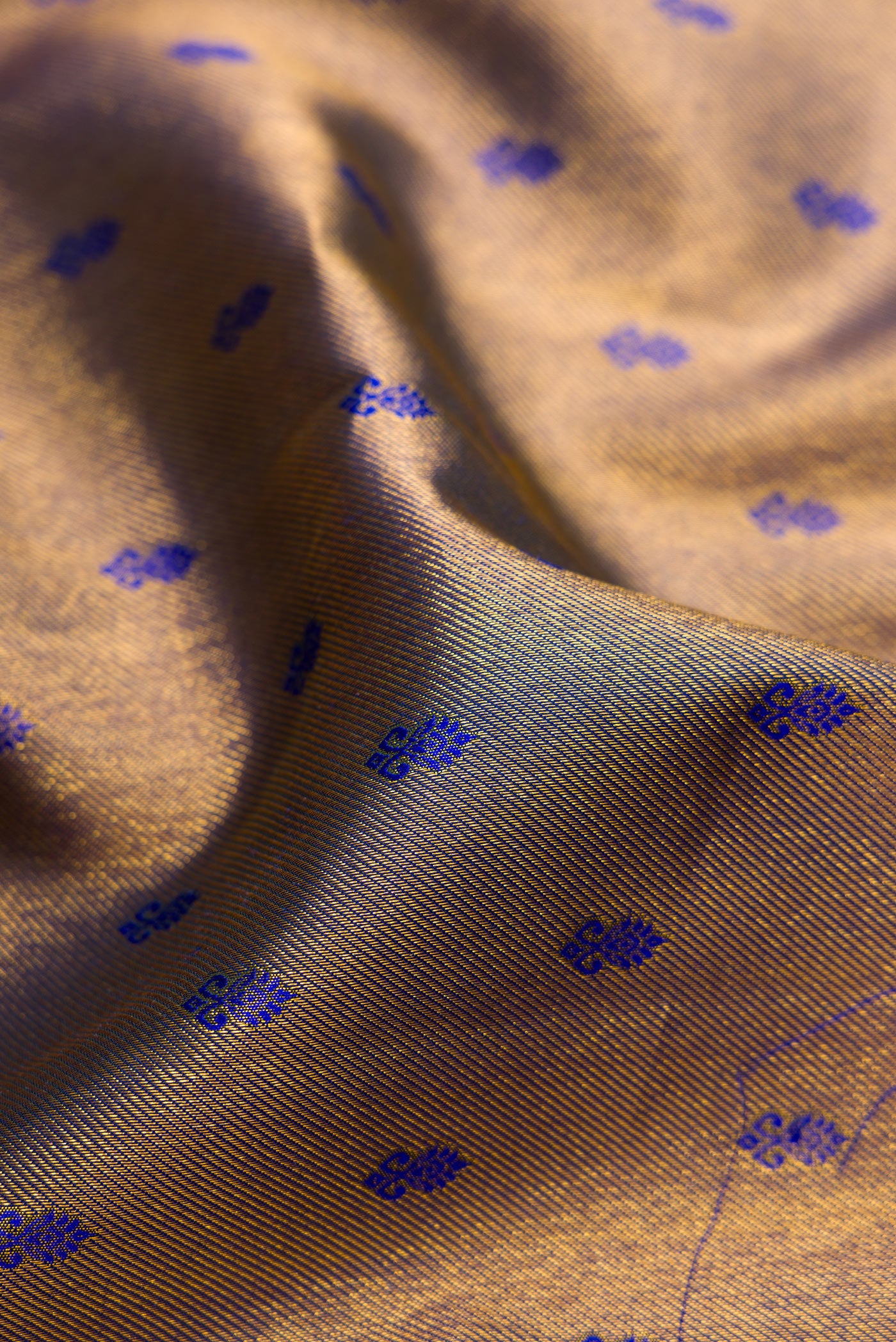 Close up of Peacock Blue Kanjivaram Silk Saree with Zari Brocade on the body and Zari Border.  displaying folds