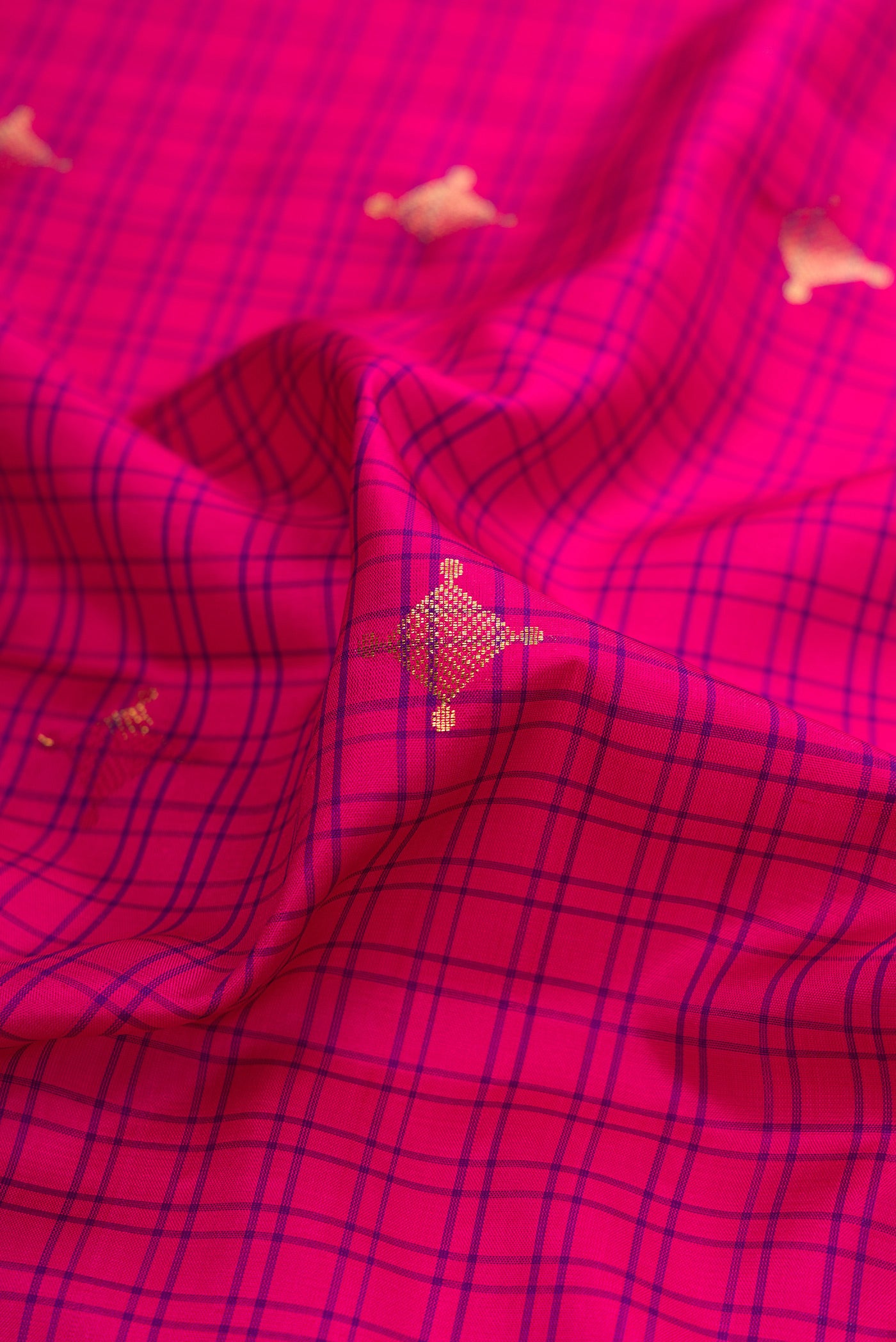 Close up of Dark Pink Soft Silk Saree with Checked design on the body and Zari Border.  displaying folds