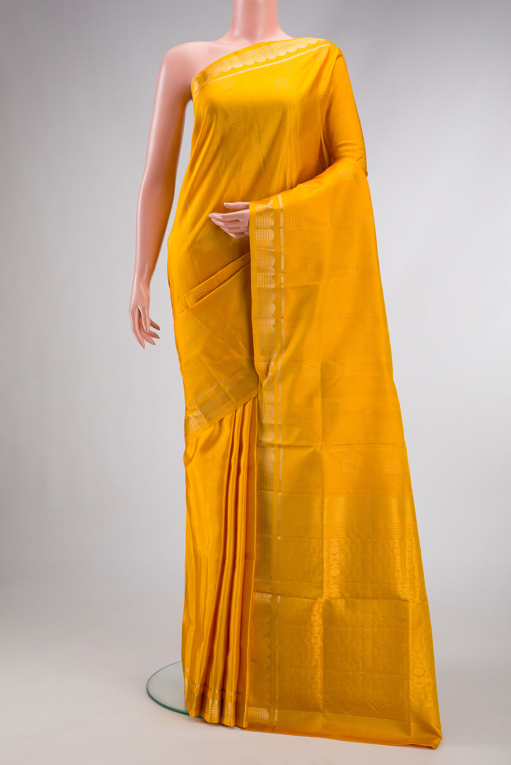 Mustard Dual Tone Soft Silk Saree with Zari Butta on the body and Zari Border.  displayed on a mannequin