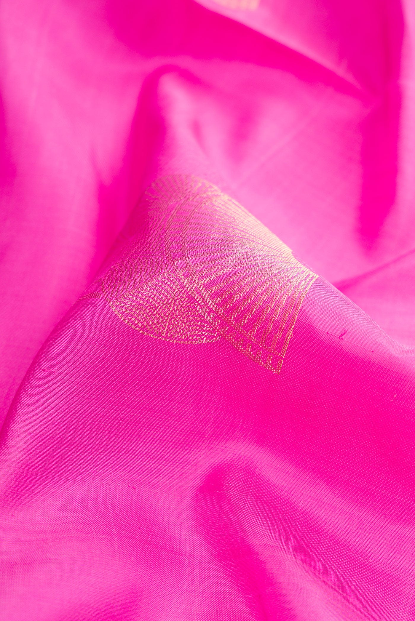 Close up of Pink Dual Tone Soft Silk Saree with Zari Butta on the body and Zari Border.  displaying folds