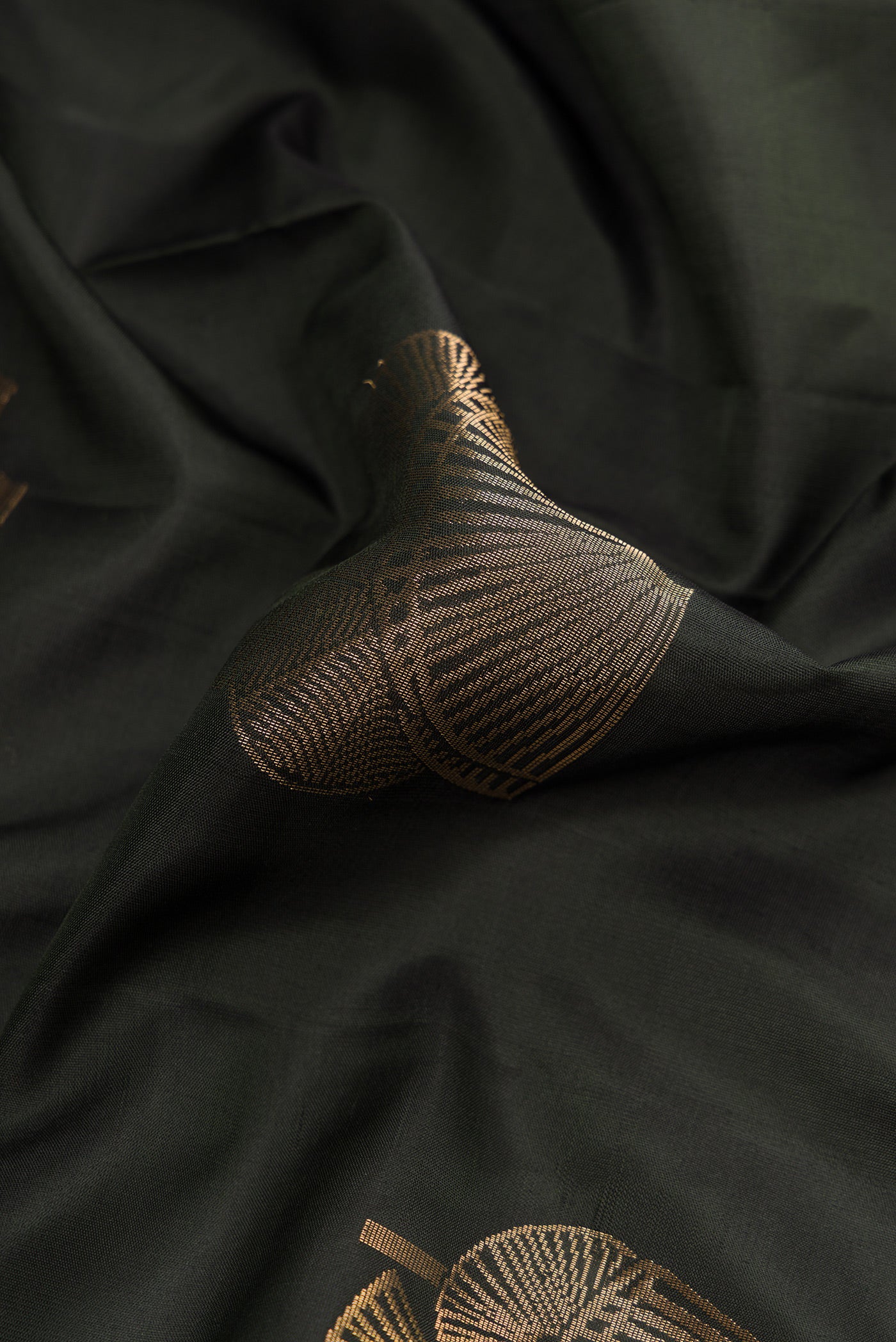 Close up of Bottle Green Dual Tone Soft Silk Saree with Zari Butta on the body and Without Border.  displaying folds