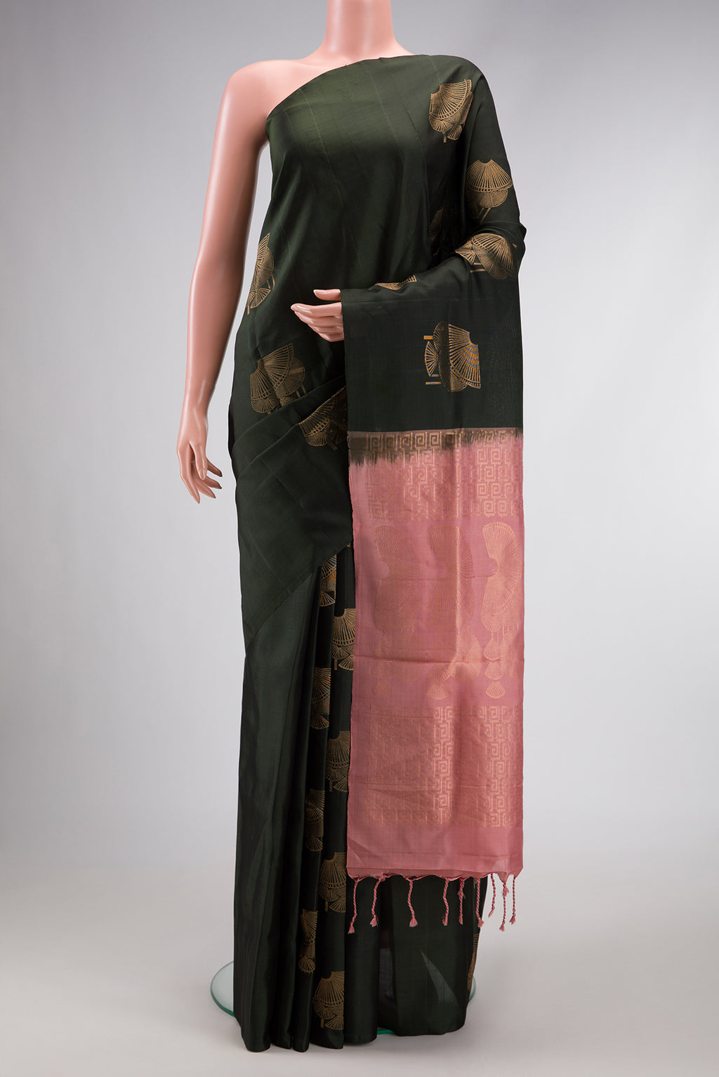 Bottle Green Dual Tone Soft Silk Saree with Zari Butta on the body and Without Border.  displayed on a mannequin