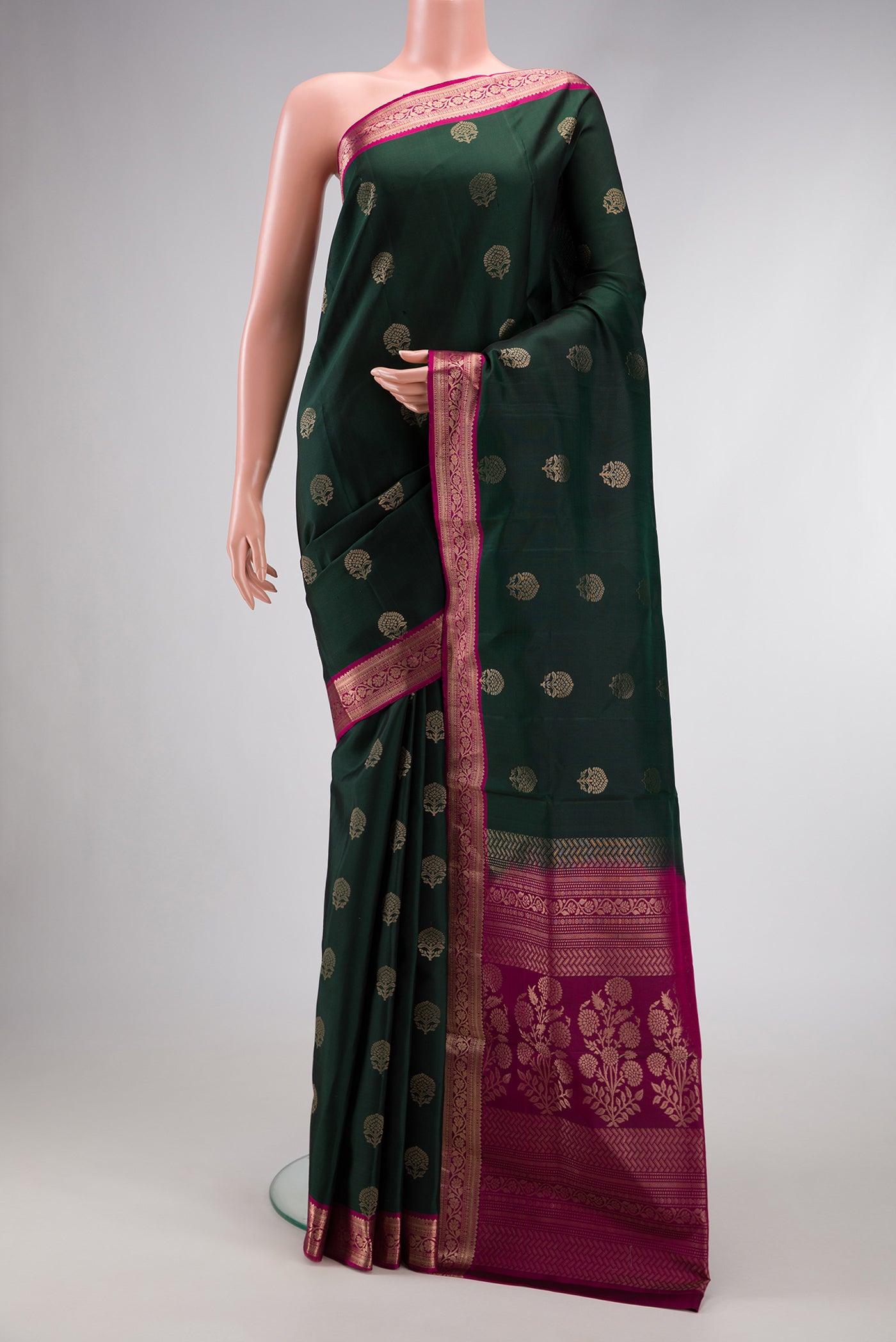 Bottle Green Dual Tone Soft Silk Saree with Zari Butta on the body and Zari Border.  displayed on a mannequin