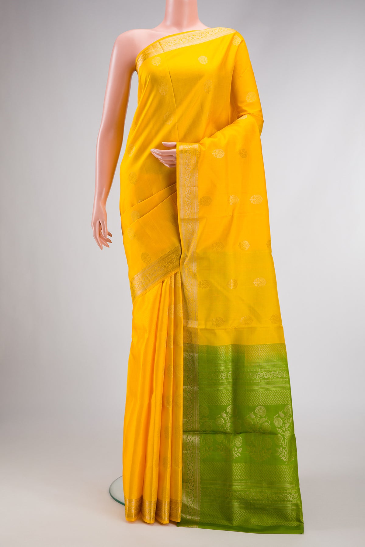 Yellow Dual Tone Soft Silk Saree with Zari Butta on the body and Zari Border.  displayed on a mannequin