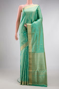 Pista Green Dual Tone Soft Silk Saree with Zari Butta on the body and Zari Border.  displayed on a mannequin