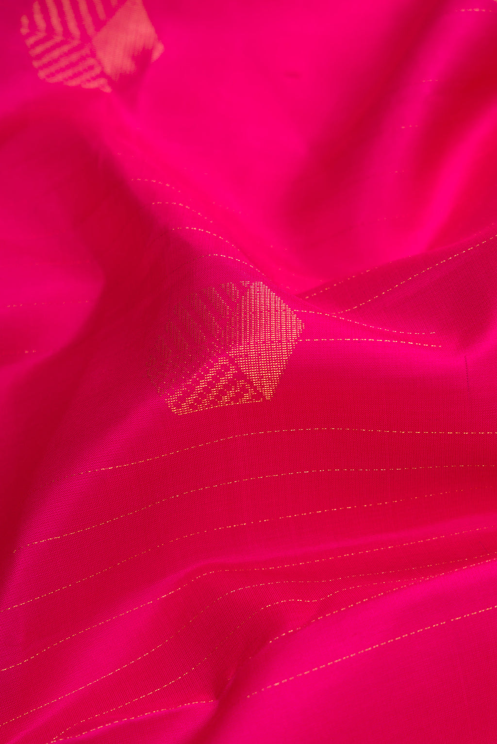 Close up of Pure Silk Pure Zari Dark Pink Dual Tone Kanjivaram Saree with Zari Butta on the body and Zari Border.  displaying folds