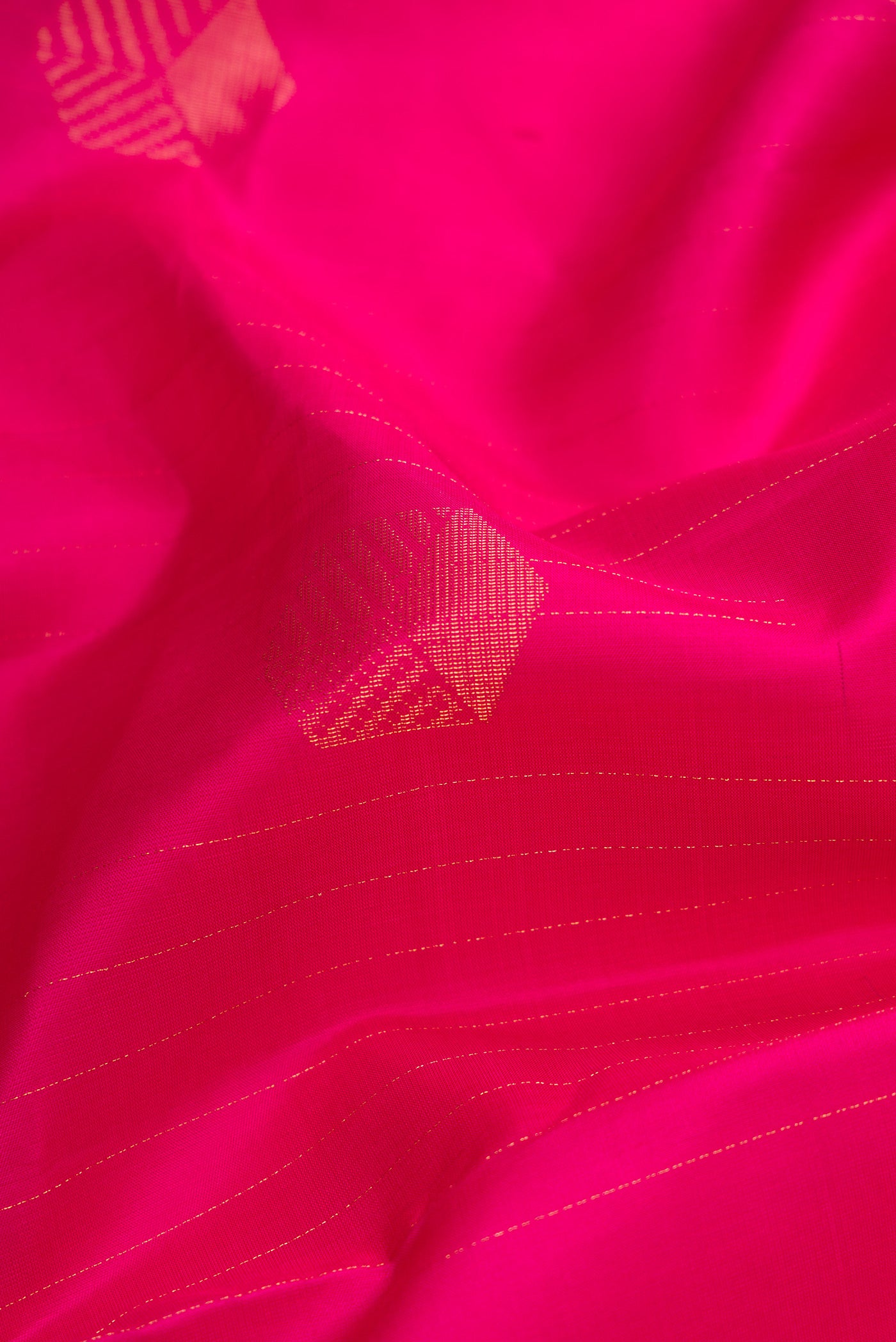 Close up of Pure Silk Pure Zari Dark Pink Dual Tone Kanjivaram Saree with Zari Butta on the body and Zari Border.  displaying folds