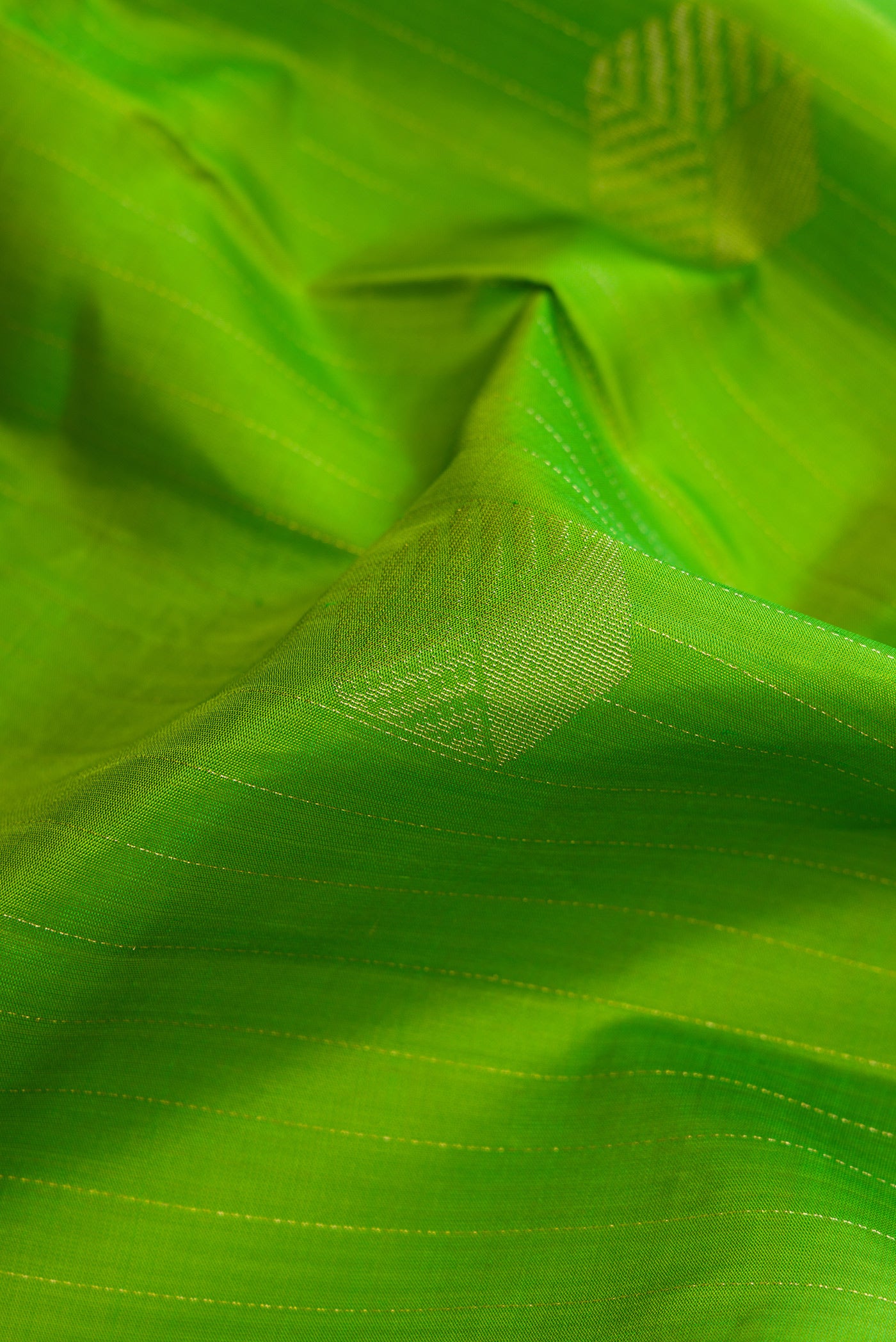 Close up of Parrot Green Dual Tone Kanjivaram Silk Saree with Stripes on the body and Without Border.  displaying folds