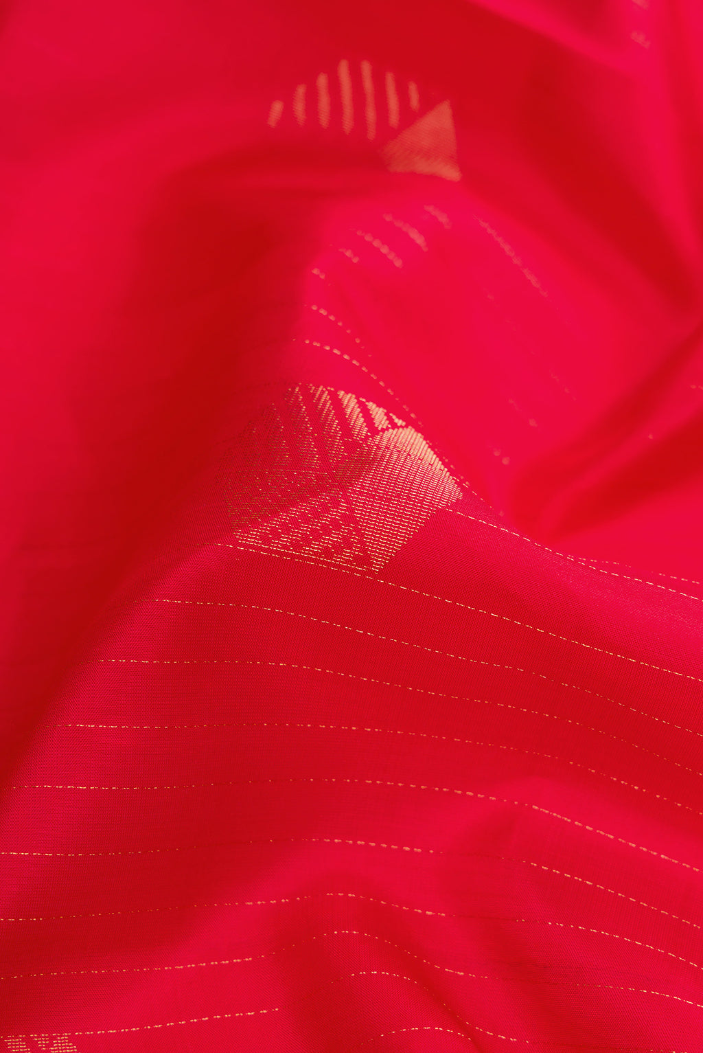Close up of Red Dual Tone Soft Silk Saree with Zari Butta on the body and Without Border.  displaying folds