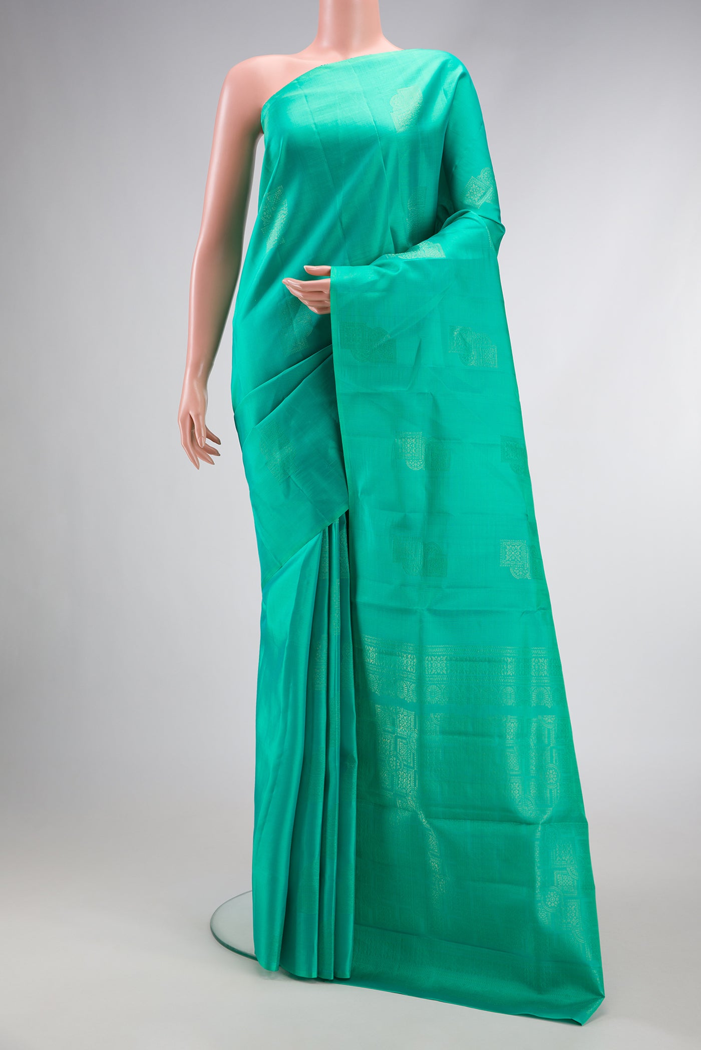 Sea Green Dual Tone Kanjivaram Silk Saree with Zari Butta on the body and Without Border.  displayed on a mannequin