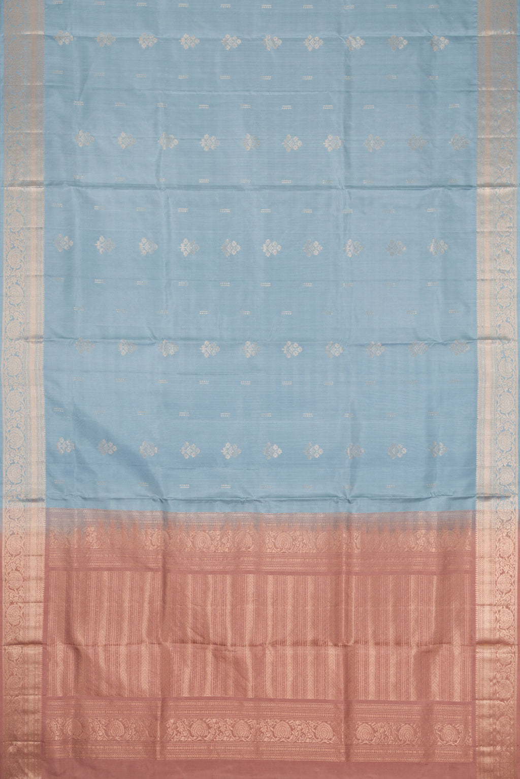Flat view of Light Blue Dual Tone Soft Silk Saree with Zari Butta on the body and Zari Border. 