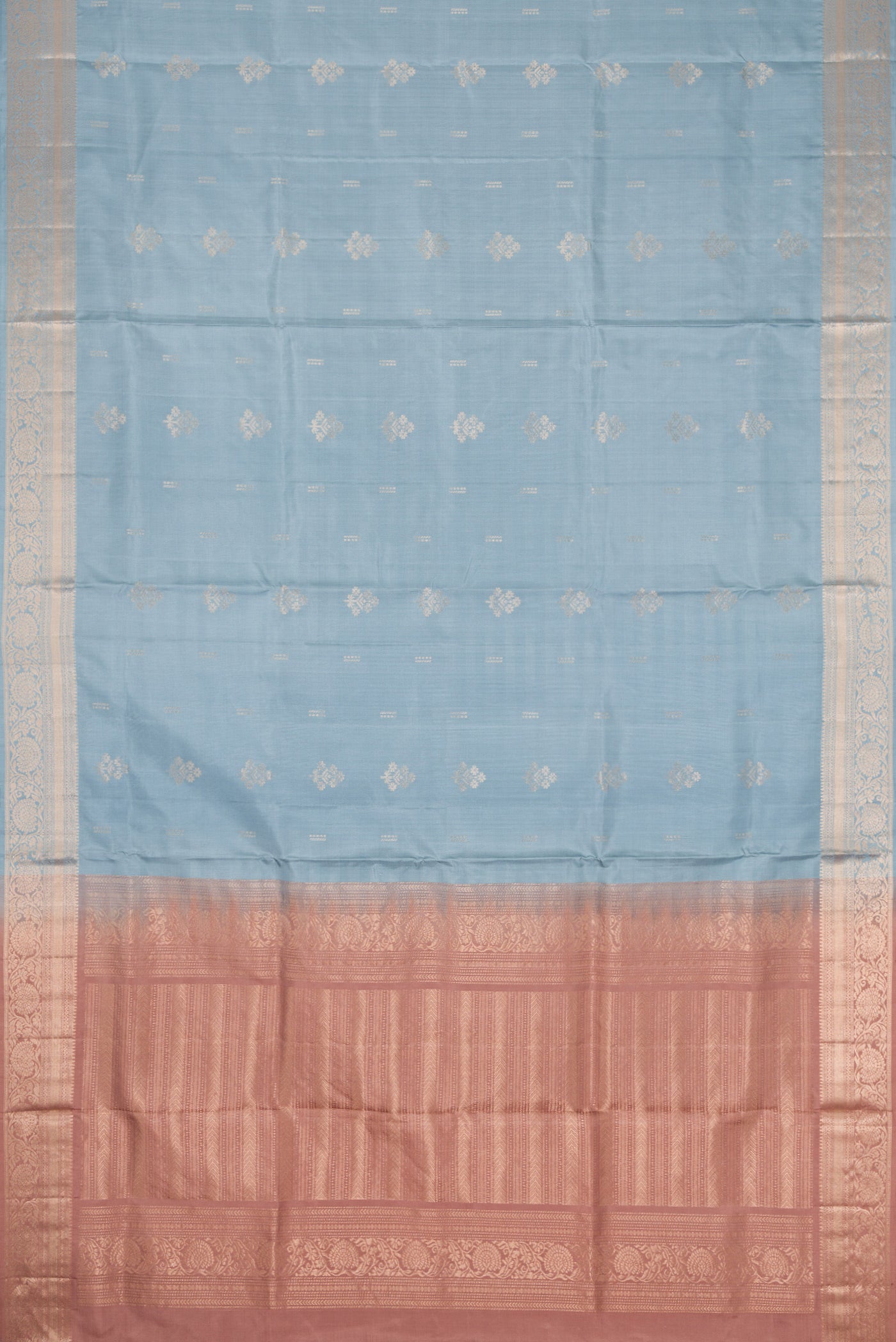 Flat view of Light Blue Dual Tone Soft Silk Saree with Zari Butta on the body and Zari Border. 