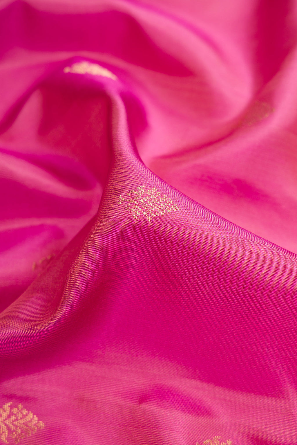 Close up of Pink Dual Tone Soft Silk Saree with Zari Butta on the body and Zari Border.  displaying folds