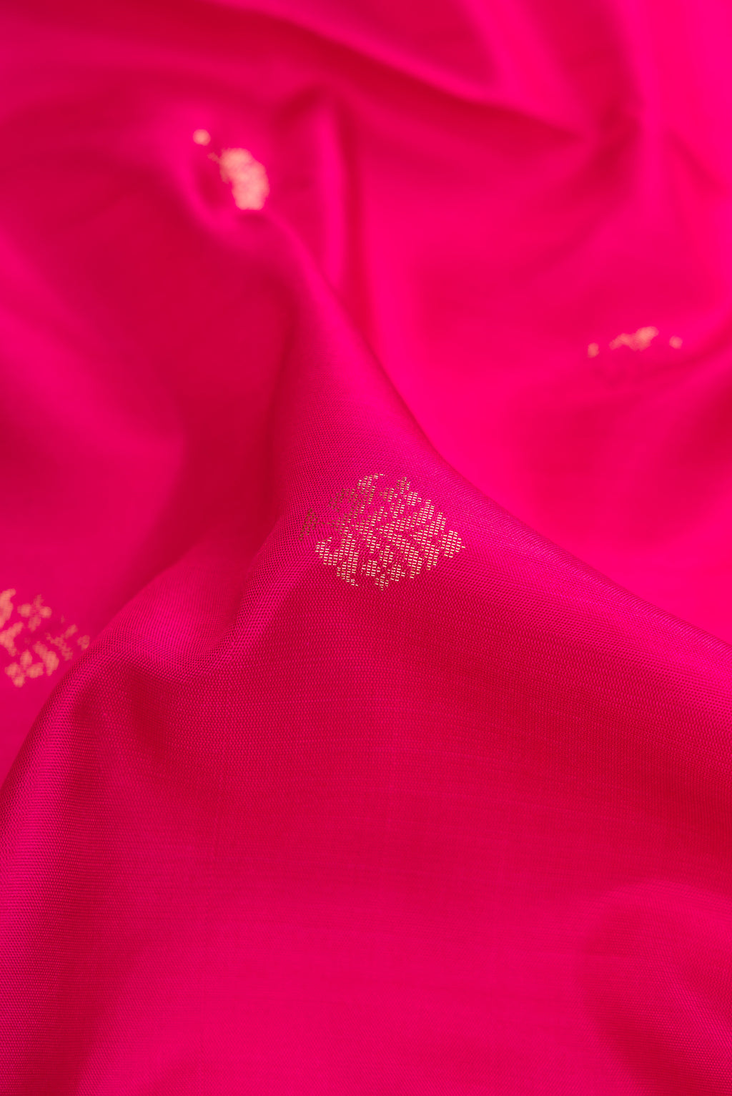 Close up of Dark Pink Dual Tone Soft Silk Saree with Zari Butta on the body and Zari Border.  displaying folds