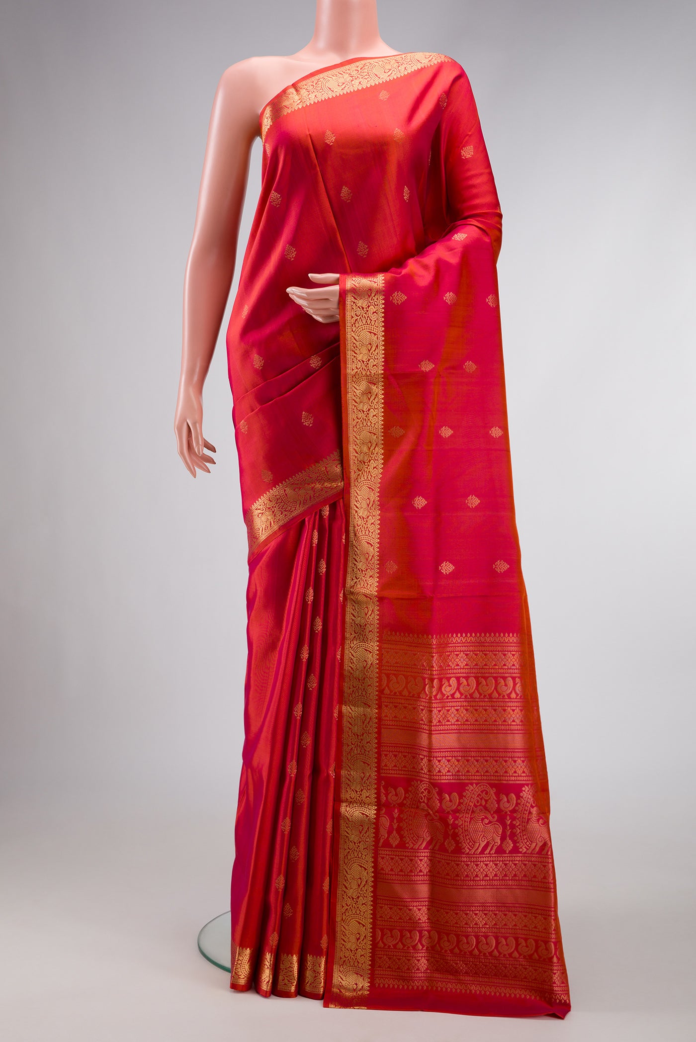 Brick Orange Dual Tone Soft Silk Saree with Zari Butta on the body and Zari Border.  displayed on a mannequin