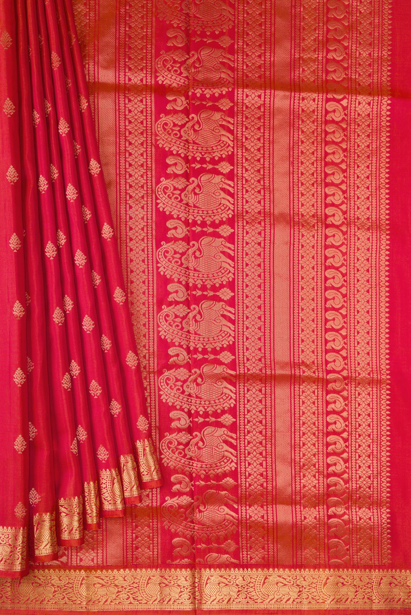 Pleats and pallu of Brick Orange Dual Tone Soft Silk Saree with Zari Butta on the body and Zari Border. 