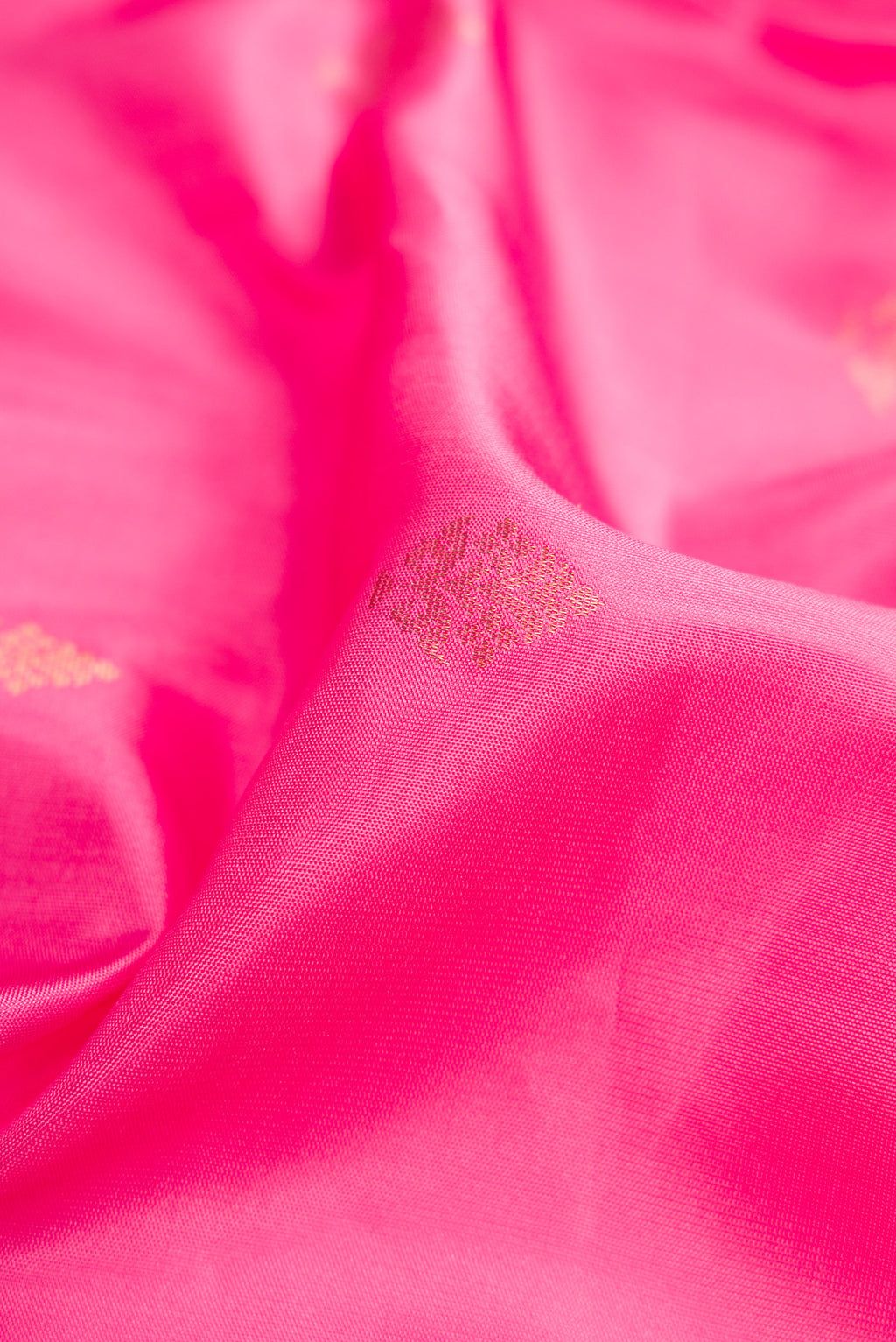 Close up of Pink Dual Tone Soft Silk Saree with Zari Butta on the body and Zari Border.  displaying folds