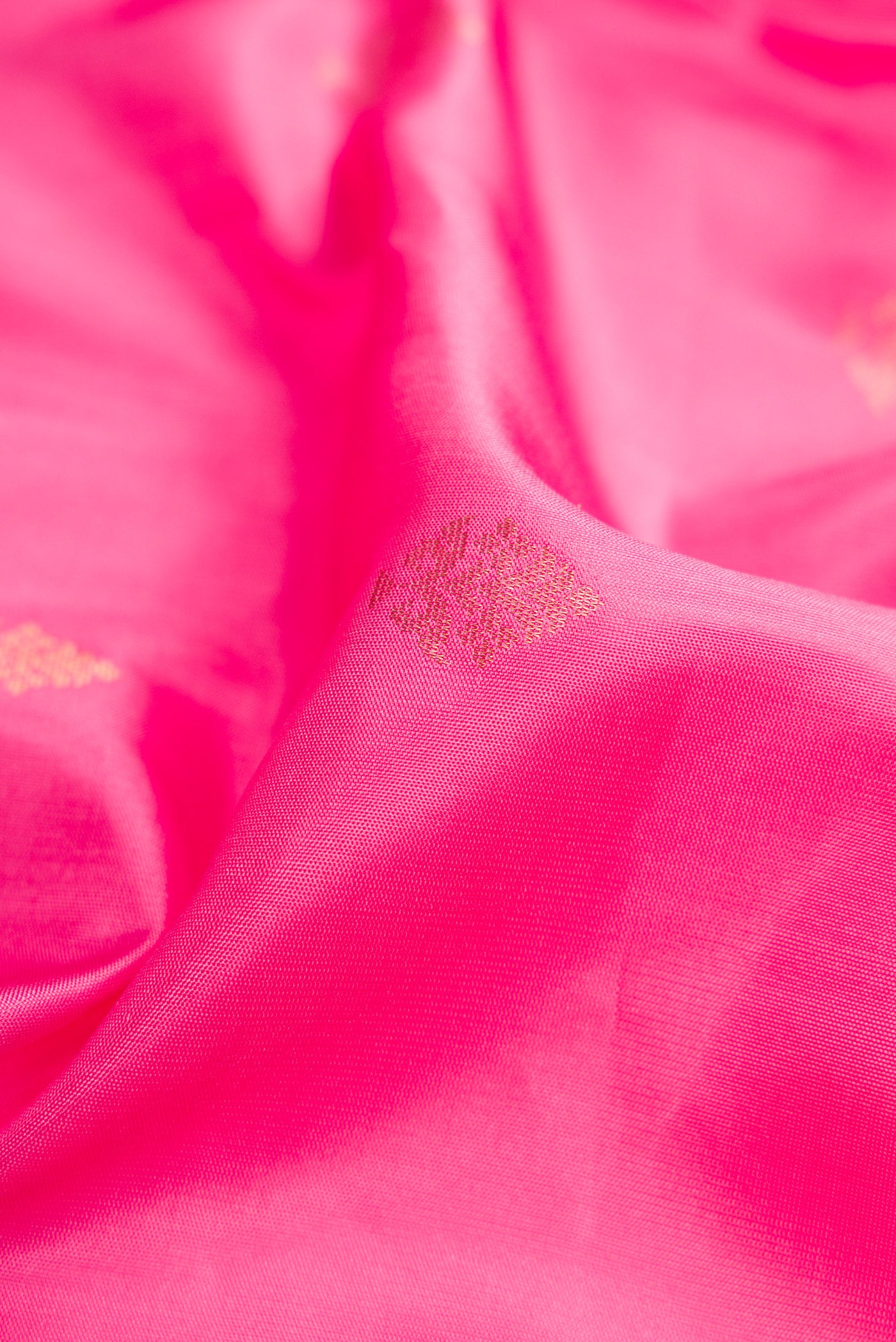 Close up of Pink Dual Tone Soft Silk Saree with Zari Butta on the body and Zari Border.  displaying folds