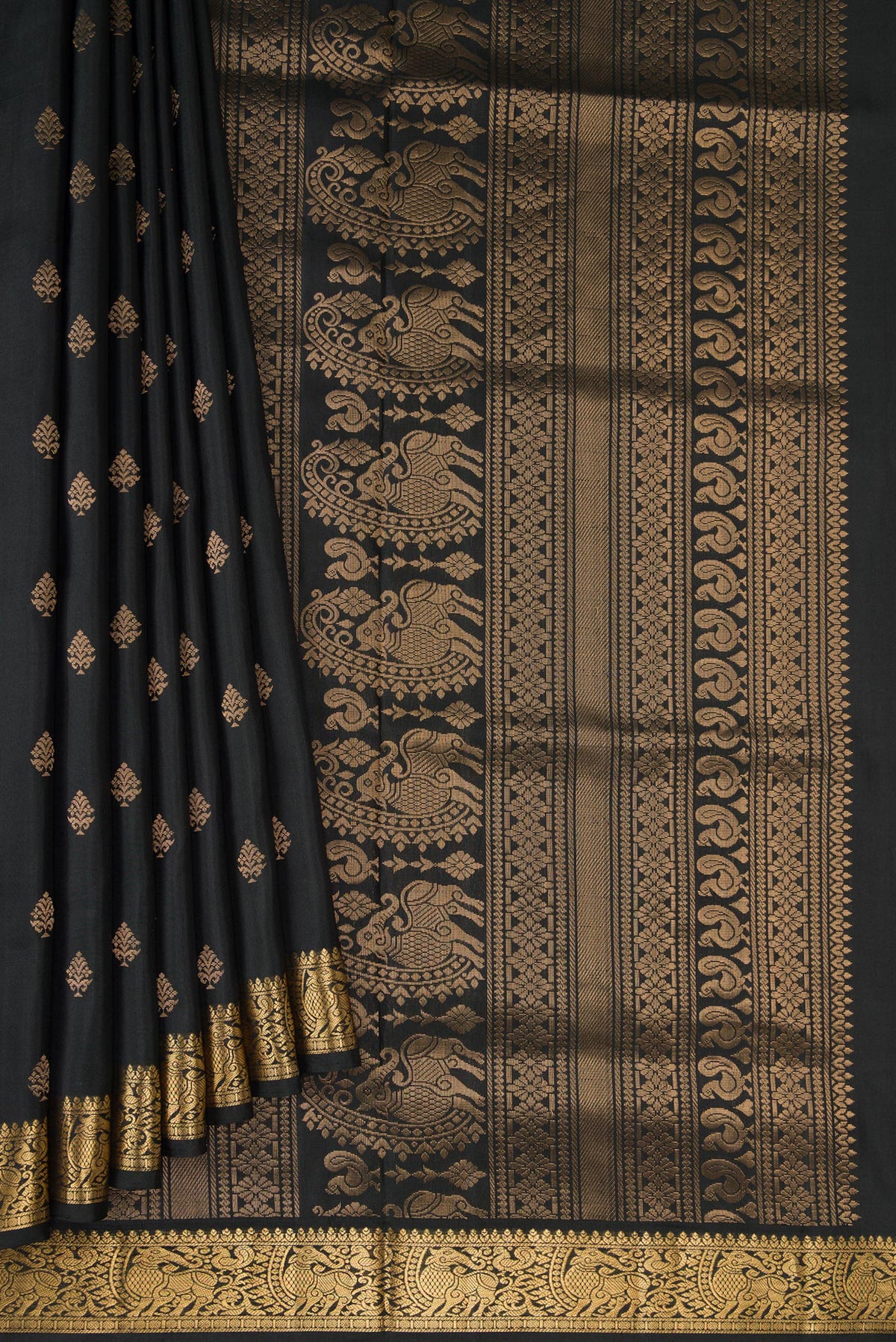 Pleats and pallu of Black Dual Tone Soft Silk Saree with Zari Butta on the body and Zari Border. 
