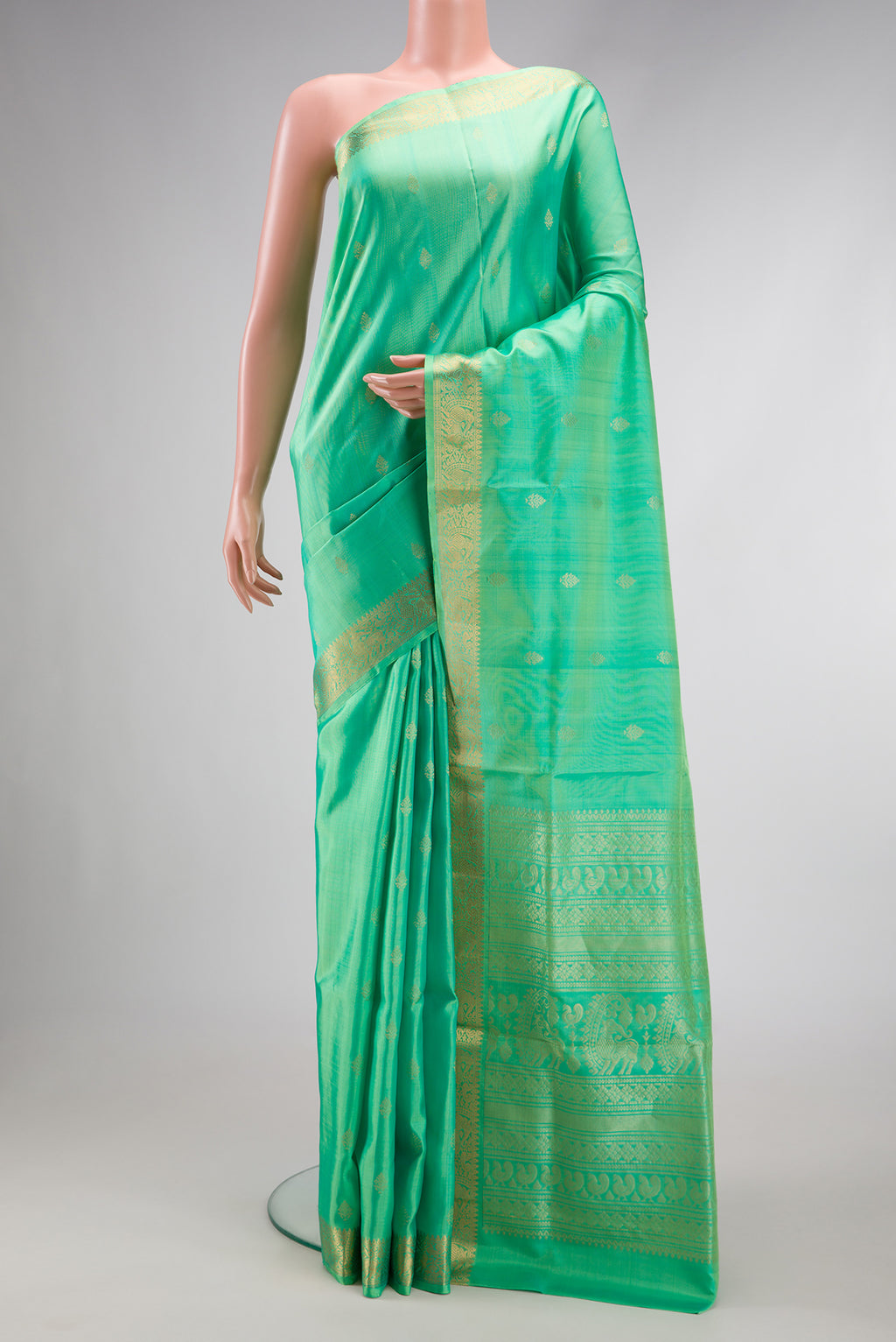 Pista Green Dual Tone Soft Silk Saree with Zari Butta on the body and Zari Border.  displayed on a mannequin