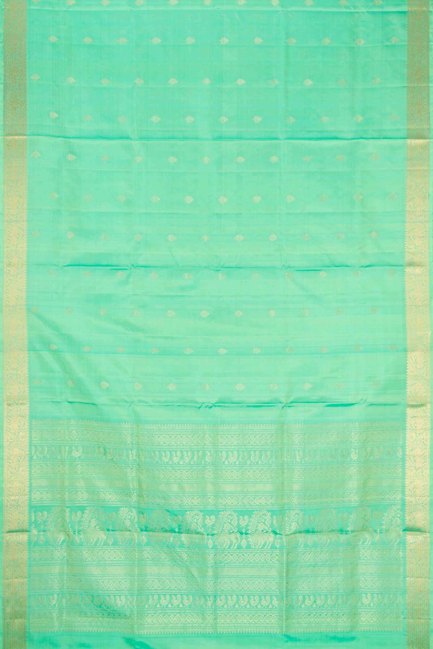 Flat view of Pista Green Dual Tone Soft Silk Saree with Zari Butta on the body and Zari Border. 