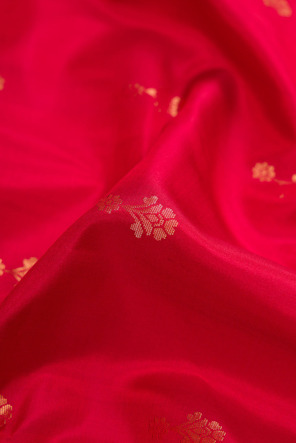 Close up of Red Dual Tone Soft Silk Saree with Zari Butta on the body and Zari Border.  displaying folds