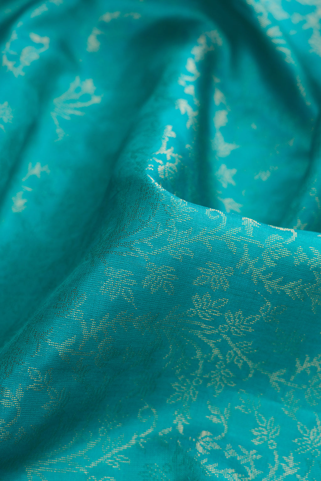Close up of Sky Blue Dual Tone Soft Silk Saree with Zari Brocade on the body and Zari Border.  displaying folds