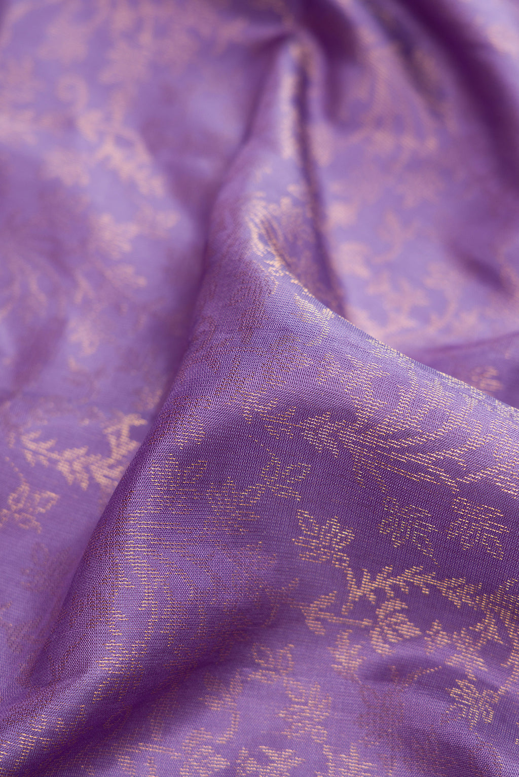 Close up of Lavender Dual Tone Soft Silk Saree with Zari Brocade on the body and Zari Border.  displaying folds