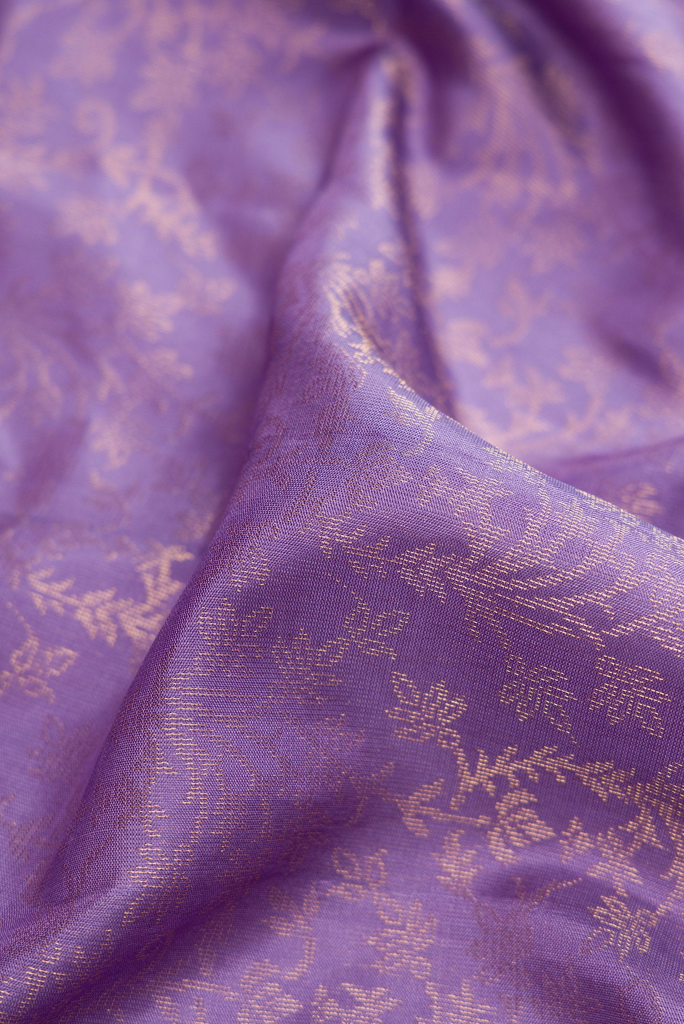 Close up of Lavender Dual Tone Soft Silk Saree with Zari Brocade on the body and Zari Border.  displaying folds