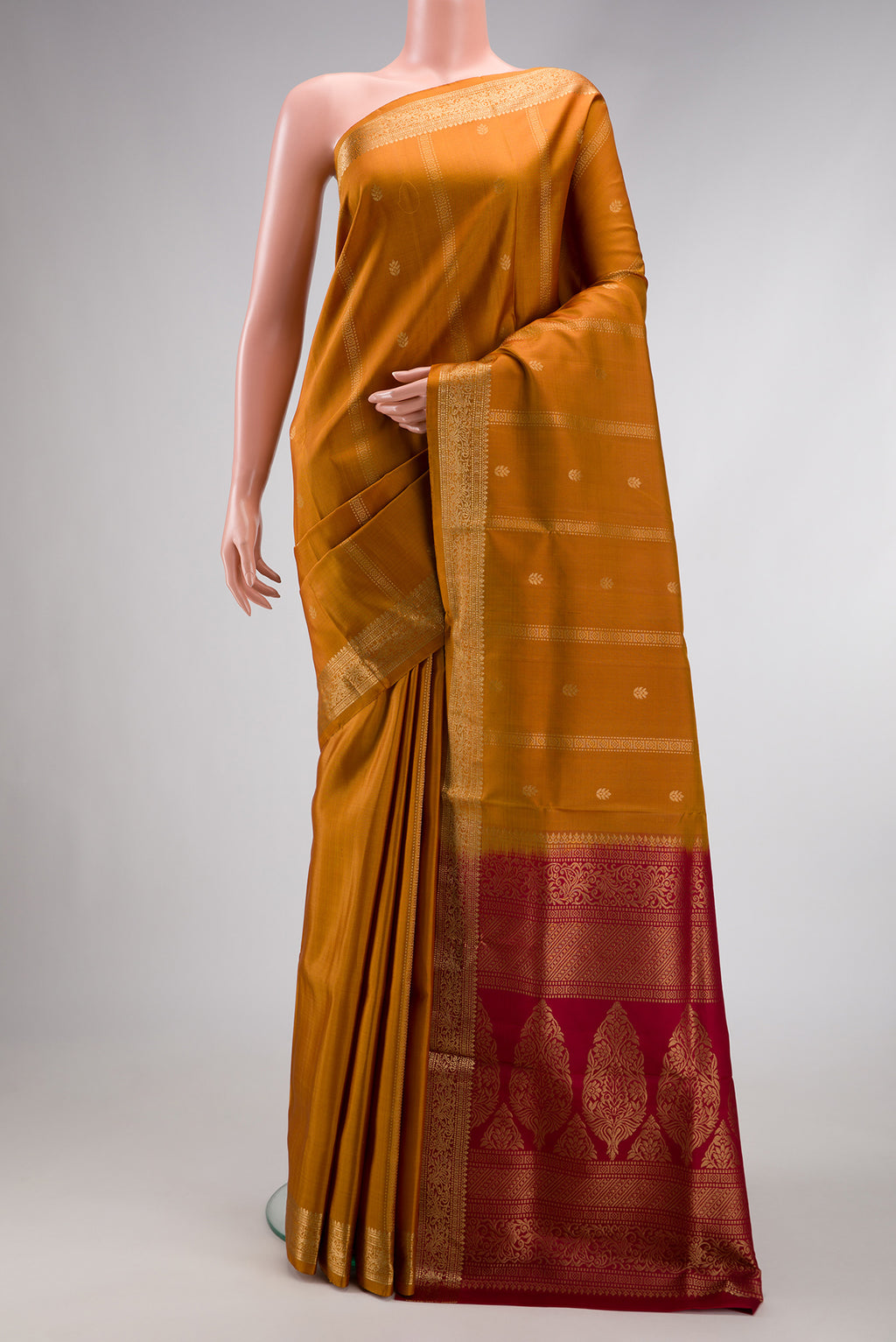 Mustard Dual Tone Soft Silk Saree with Zari Butta on the body and Zari Border.  displayed on a mannequin